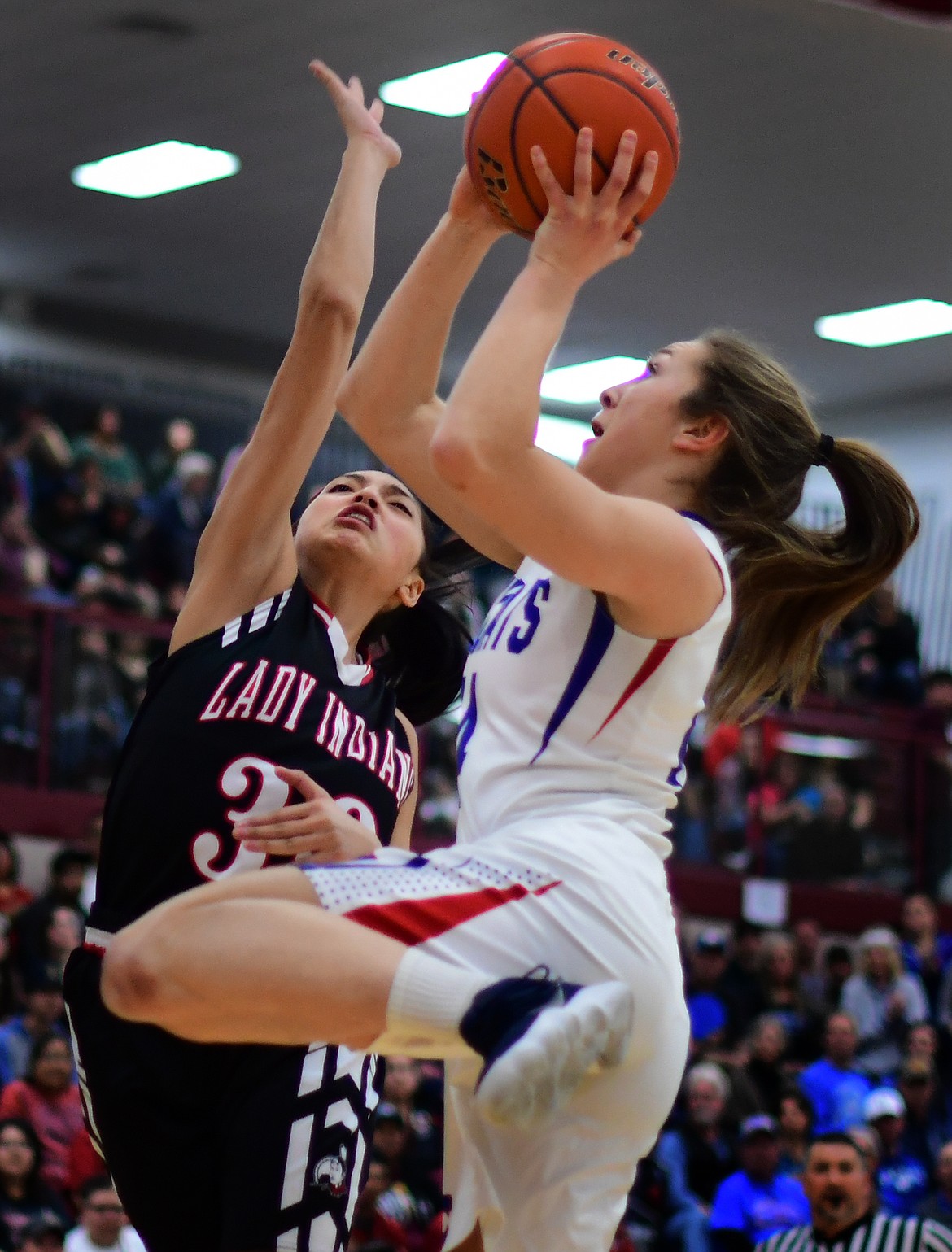 Josie Windauer goes up over Browning&#146;s Dulci Skunkcap for two of her team-high 16 points Saturday. (Jeremy Weber photo)