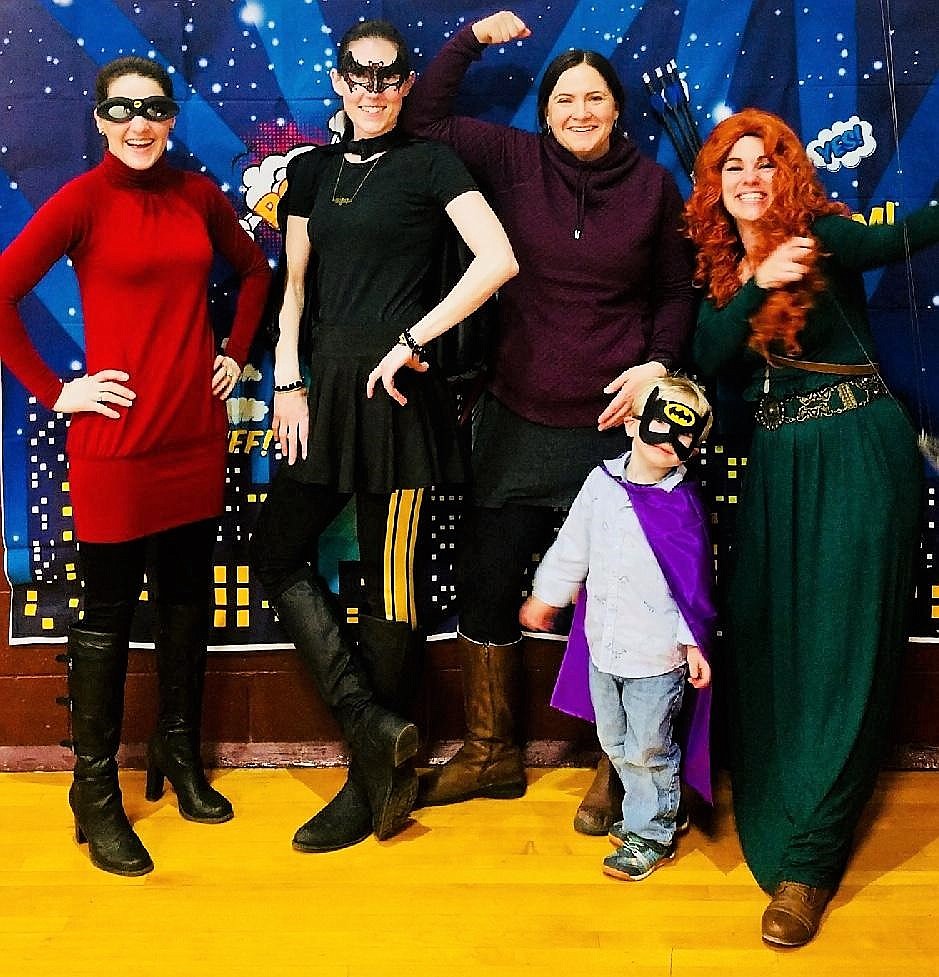 Super Heros Carissa Kuhl (far left), Jose Johnson, Richae Rausch, her son Gus, and Jesse Mauer (far right) gathered for a super-powered photo at a Super Hero Princess Party on Saturday at the Alberton School. (Photo courtesy of Jesse Mauer)