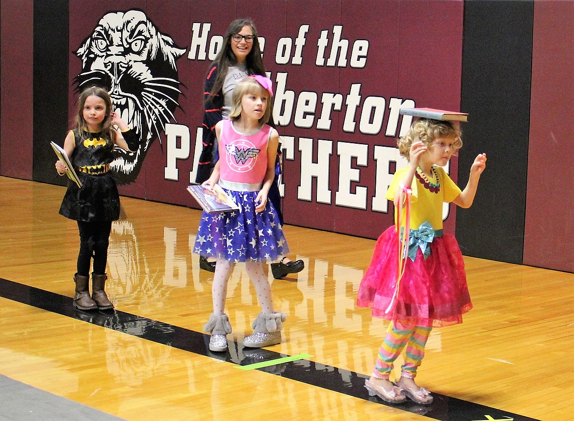 Balance a book and curtsy was a princess game at the Super Hero Princess Party in Alberton on Feb. 23. Olivia White gives it a try (right), while sister Ava (middle) waits her turn. 
(Kathleen Woodford/Mineral Independent).