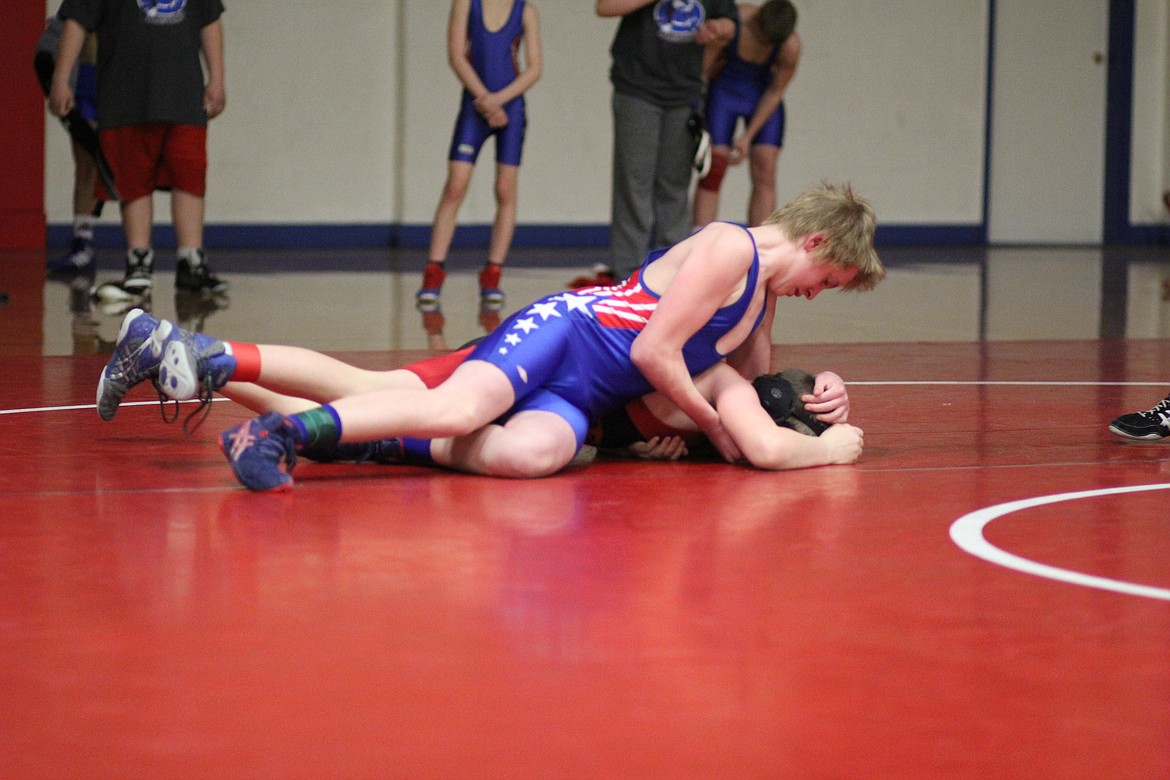 Clark Fork Mountain Cat Olan Doyle takes down Plains/Hot Springs Spur Ryan during a Little Guy Wrestling match in Superior on Feb. 21. (Kathleen Woodford/Mineral Independent)