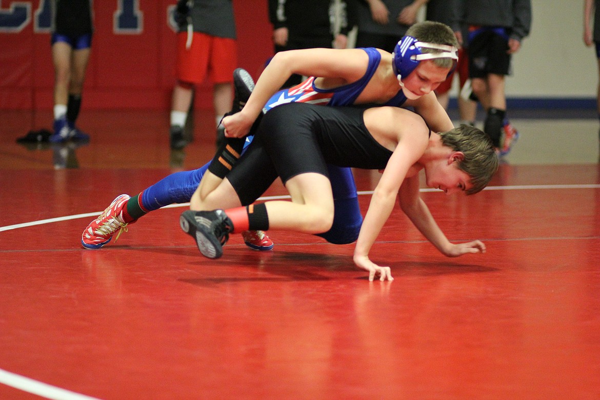 In an 85-pound match, Clark Fork Mountain Cat Isaac Miller is matched up against Plains/Hot Spring&#146; John Thurston last Thursday. (Kathleen Woodford/Mineral Independent)