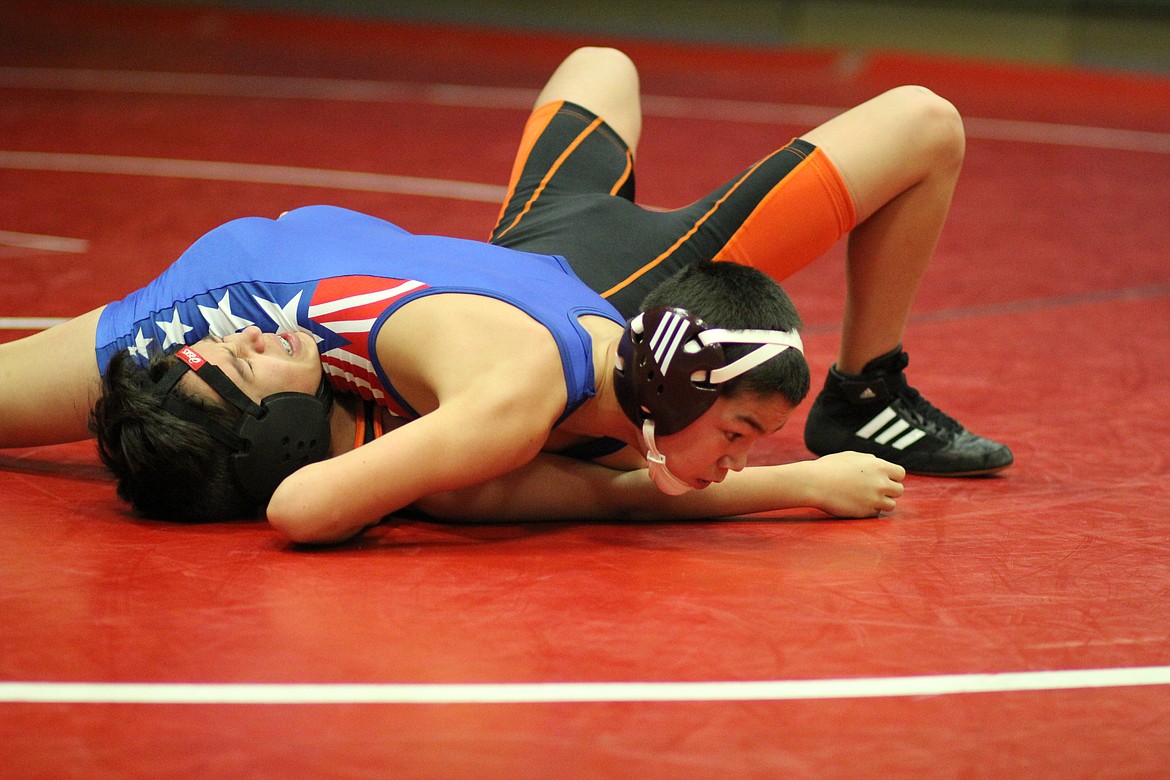 Lucas Kovalsky with the Clark Fork Mountain Cats pins Plains/Hot Springs Gunner Gannarelli last Thursday in Superior. (Kathleen Woodford/Mineral Independent)