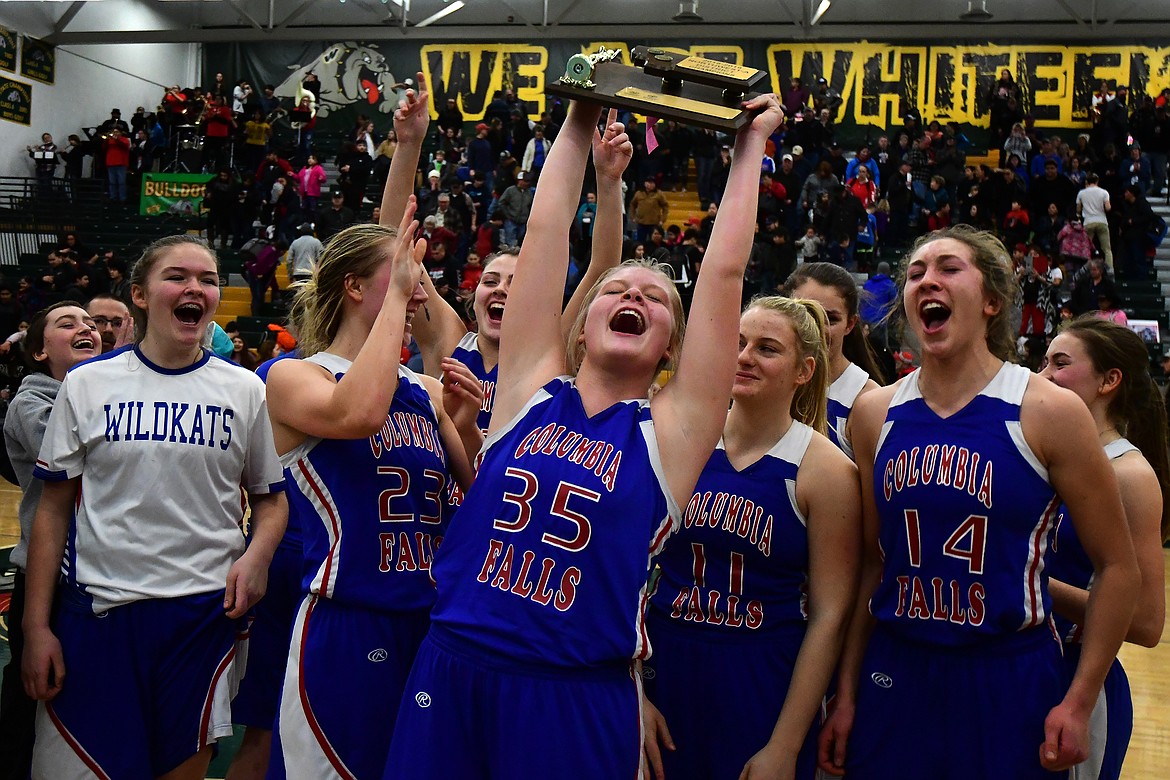 The Wildkats celebrate with the trophy after winning the Northwest A District Tournament Saturday. (Jeremy Weber photo)