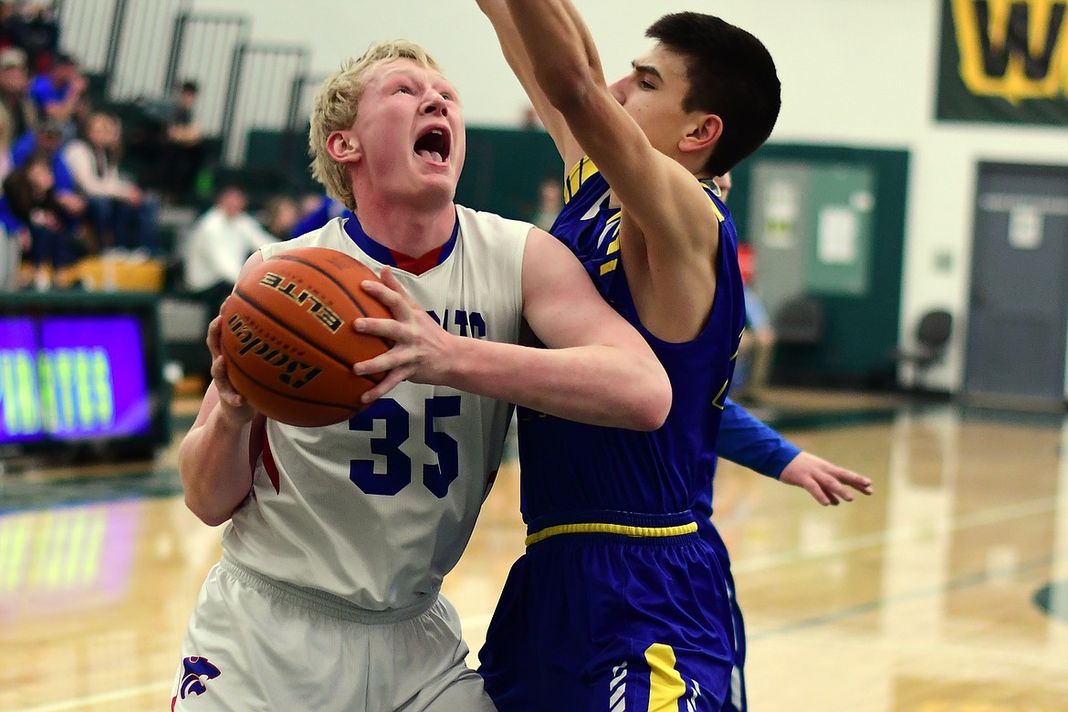 Sam Hovde muscles his way into the paint for two of his team-high 22 points against Libby Saturday. (Jeremy Weber photo)