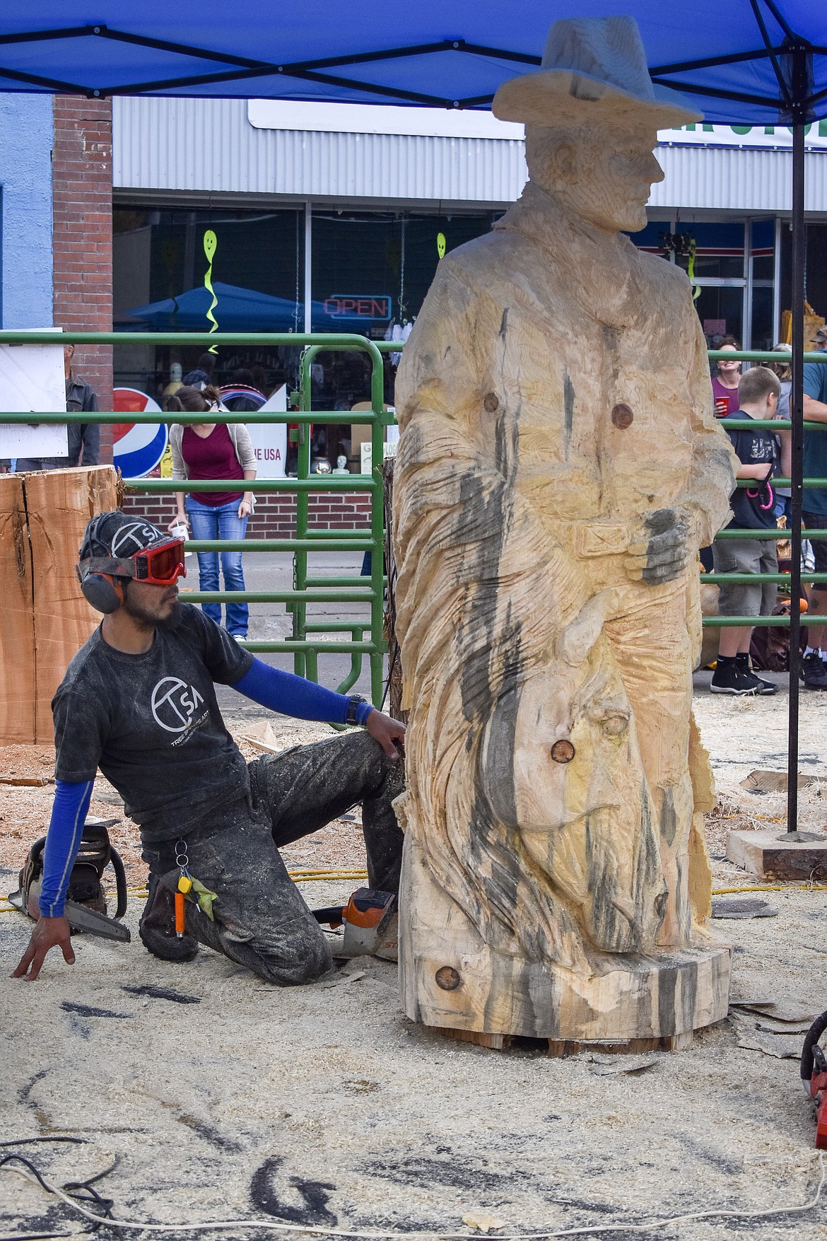 Hikaru Kodama from Japan takes a moment to examine his artwork during the Kootenai Country Montana Chainsaw Carving Championship on Saturday, Sept. 23, 2018. (Ben Kibbey/The Western News)