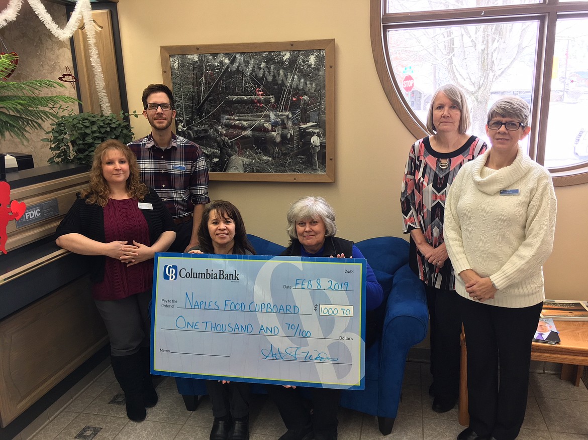 Courtesy photo
Columbia Bank volunteers present a check for $1,000 to Naples Food Cupboard. The donation was part of the bank&#146;s Warm Hearts Winter Drive, which raises money and provides warm clothing to organizations which help people experiencing homelessness.