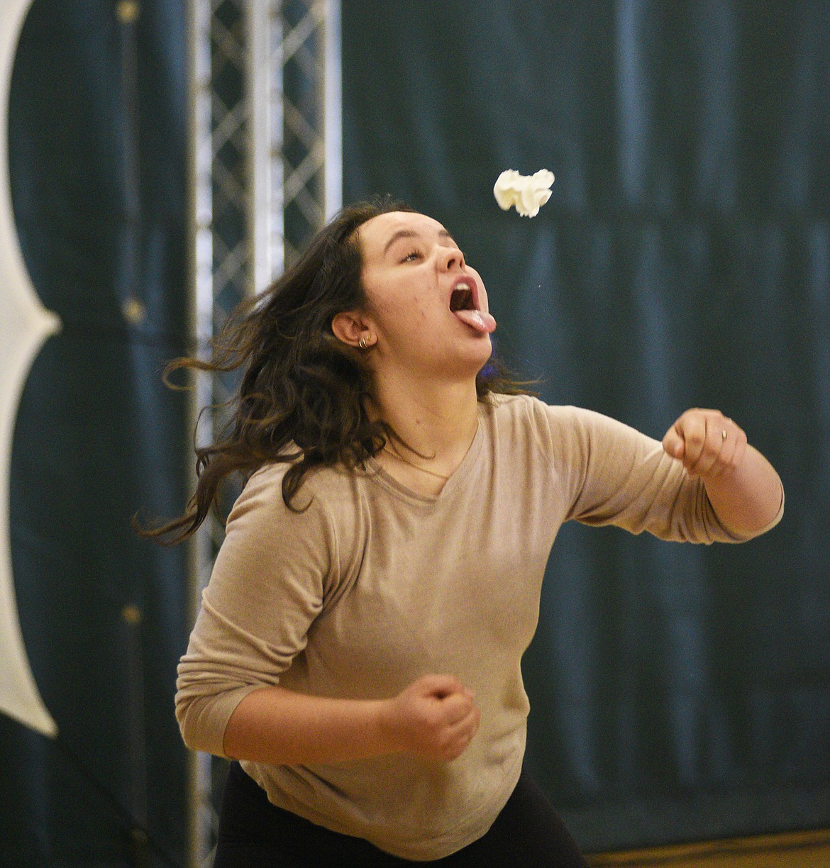 A student tries to catch some whipped cream in a competition during iThinkBig's assembly last Wednesday at Whitefish High School. (Daniel McKay/Whitefish Pilot)