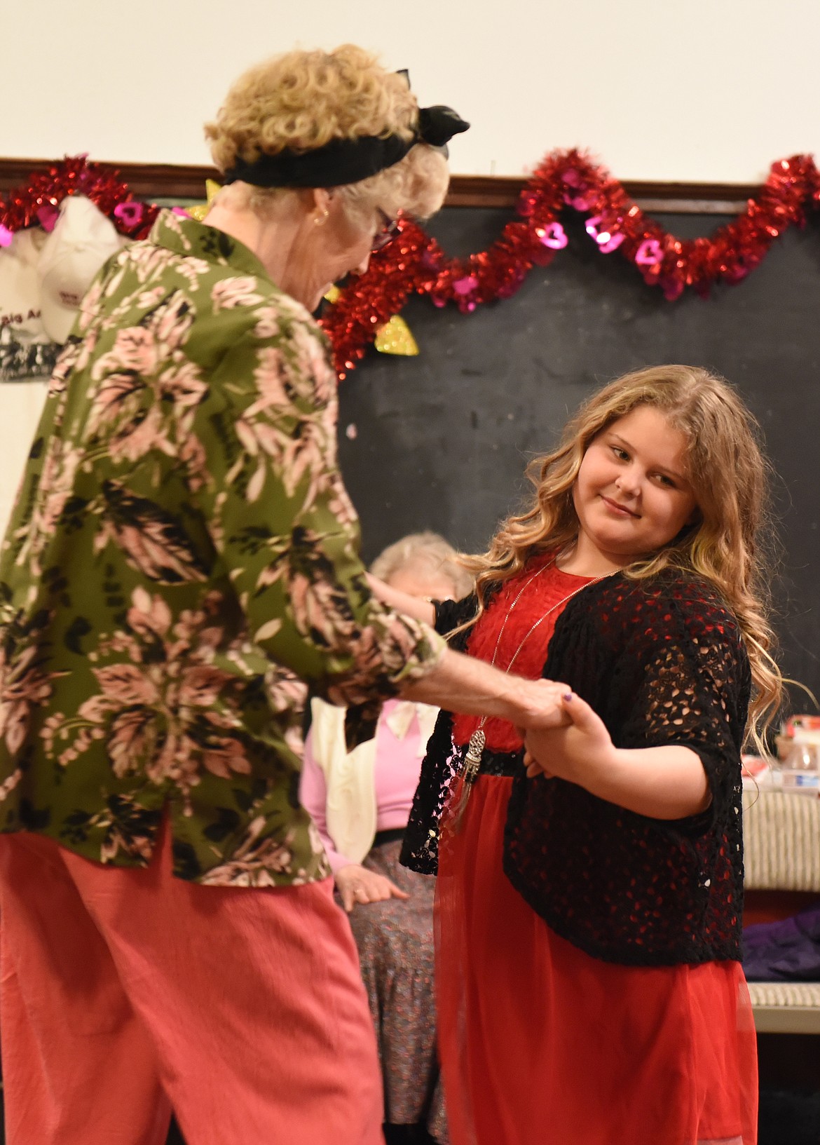 ABIGAIL SANFORD, a third-grader from Polson, dances with Darline Hoyt.