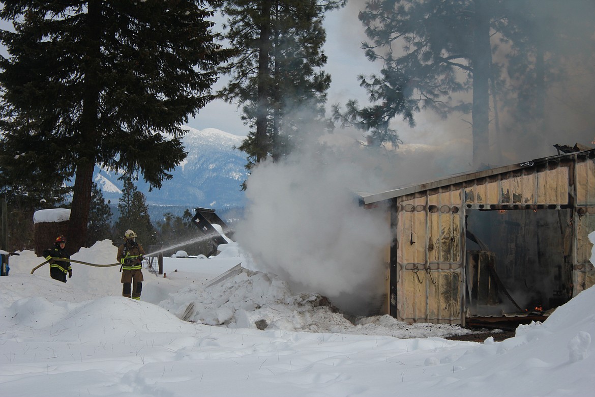 Photo by TANNA YEOUMANS
Firefighters worked in the freezing temperatures to keep the fire under control.