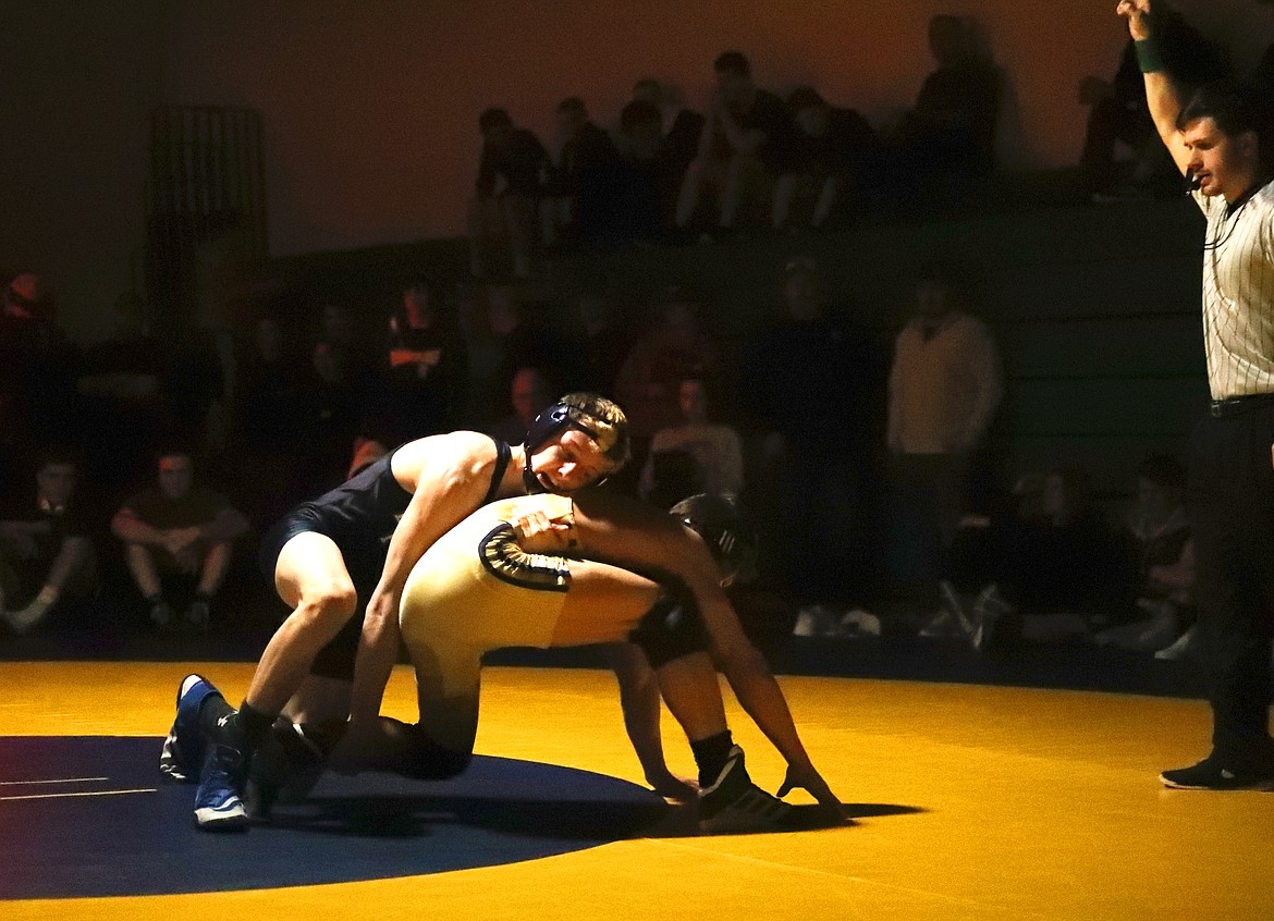 (Photo by KYLE CAJERO) Bonners Ferry freshman Eli Richards prevents Timberlake junior Louis Powell from escaping during the 3A 145-lb. district championship match.