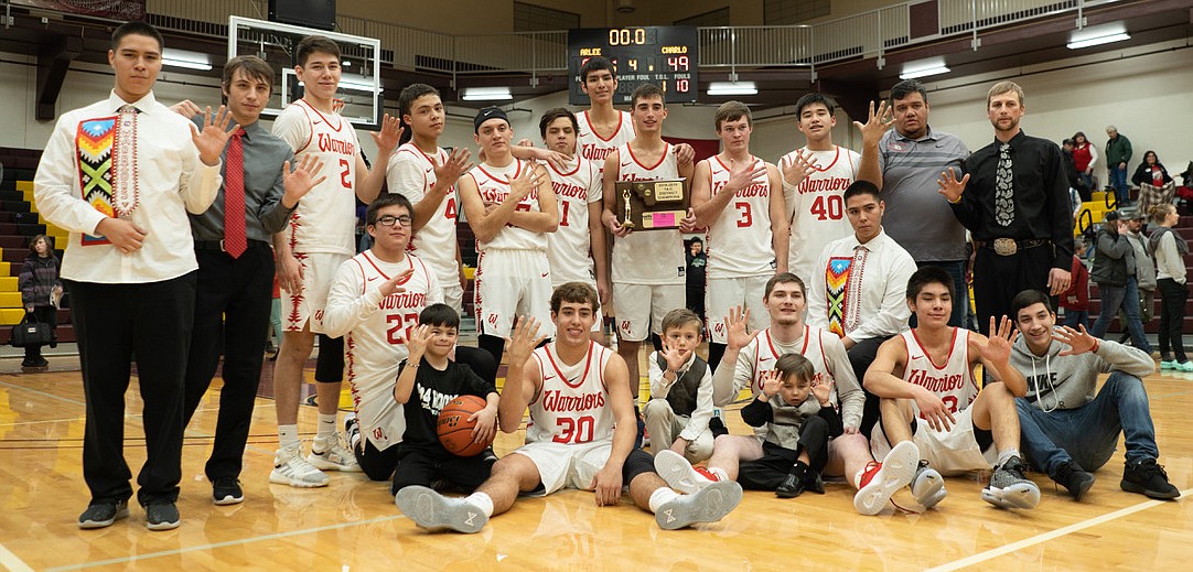 THE ARLEE Warriors show their championship trophy after rolling past Charlo 80-49 to win the 14C District Tournament title Saturday night at Joe McDonald Gym at SKC in Pablo. (Photo courtesy of Jordan Lefler)