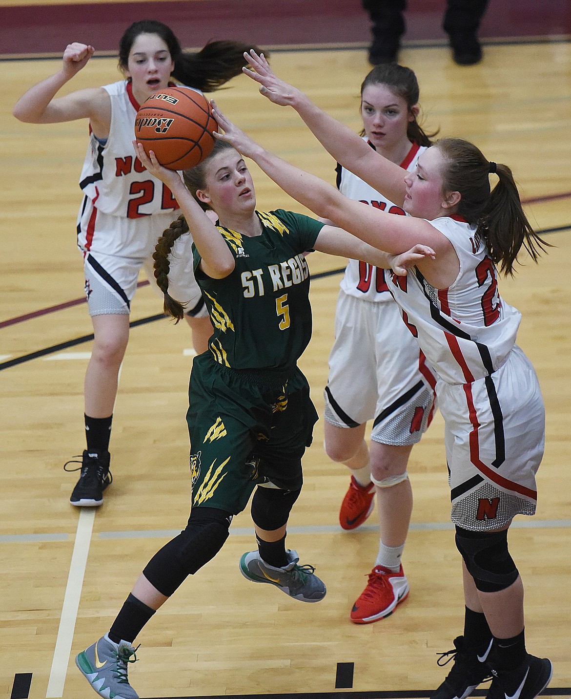 ST. REGIS senior Madison Kelly (5) attempts a shot over Delaney Weltz of Noxon during their 14C District Tournament loser-out game. The Lady Tigers won 45-26, but were eliminated by Plains 53-31 and finished fourth. (Joe Sova/Mineral Independent)