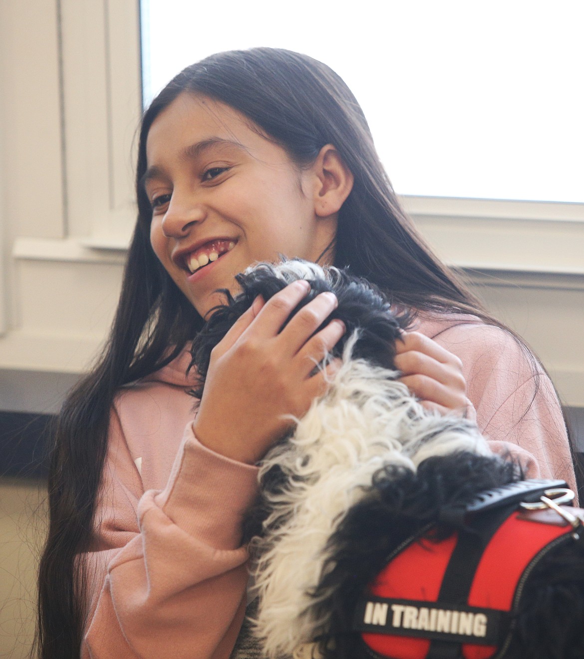 Blue, a 12-week-old therapy dog in training, visited students yesterday at Winton Elementary School. Here, Blue gives fifth-grader Giovanna Amador a kiss during his visit to the school&#146;s Library. (LOREN BENOIT/Press)