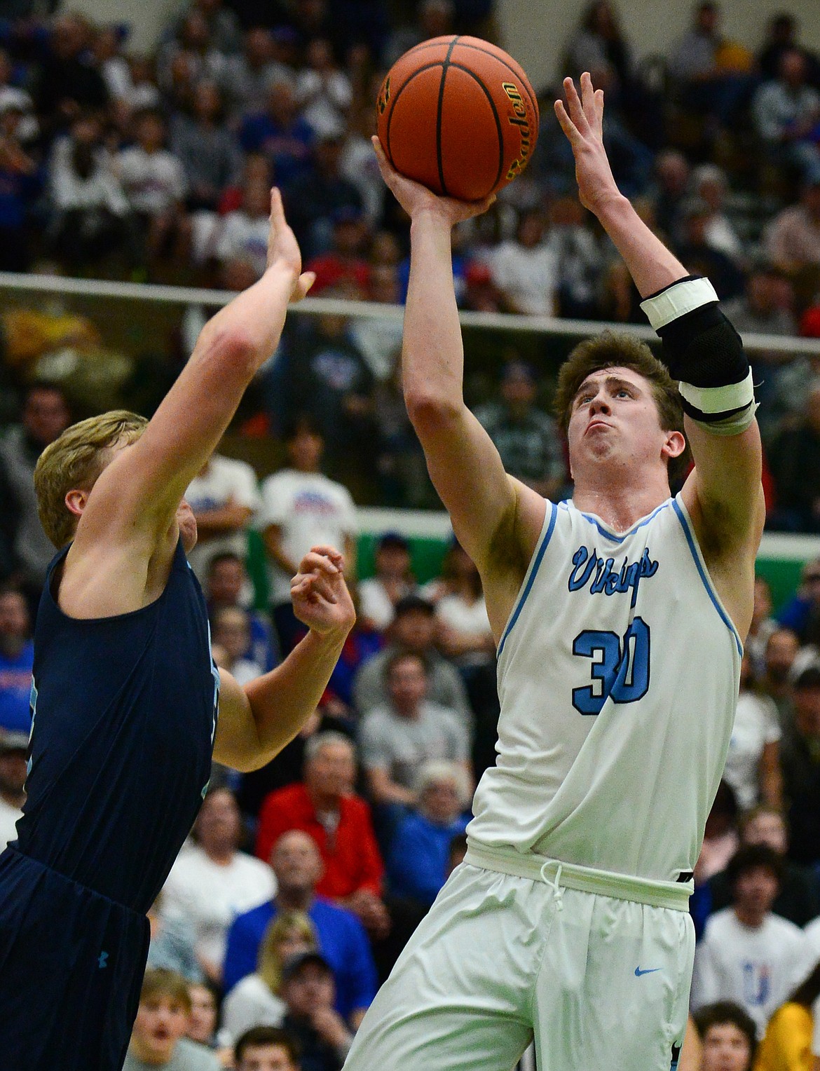 Bigfork's Logan Gilliard (30) drives to the hoop against Loyola Sacred Heart's Ryan Tirrell (2)  in the State Class B boys' basketball championship at the Belgrade Special Events Center in Belgrade on Friday. (Casey Kreider/Daily Inter Lake)