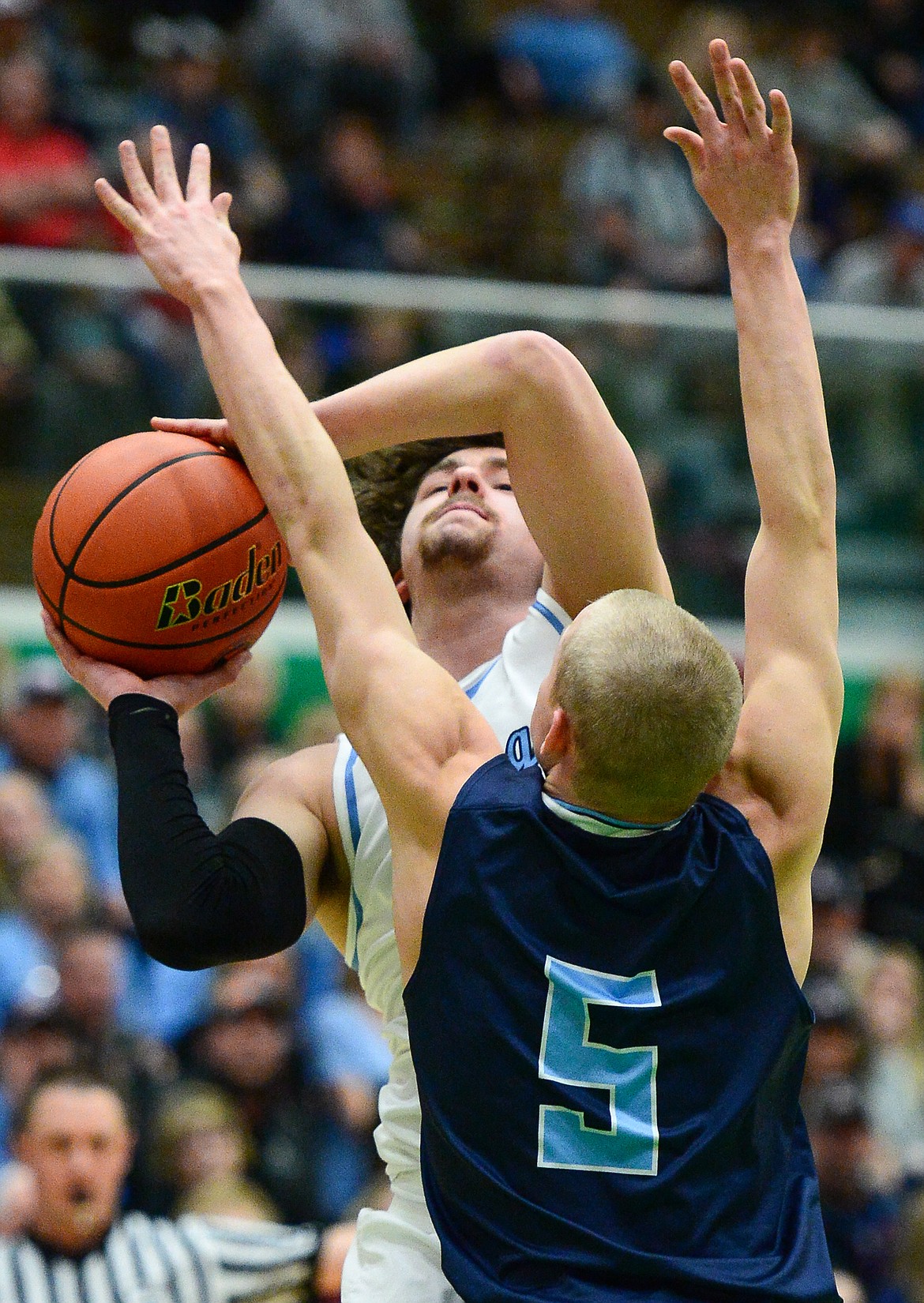Bigfork's Anders Epperly (0) drives to the hoop against Loyola Sacred Heart's Jacob Hollenback (5) in the State Class B boys' basketball championship at the Belgrade Special Events Center in Belgrade on Friday. (Casey Kreider/Daily Inter Lake)