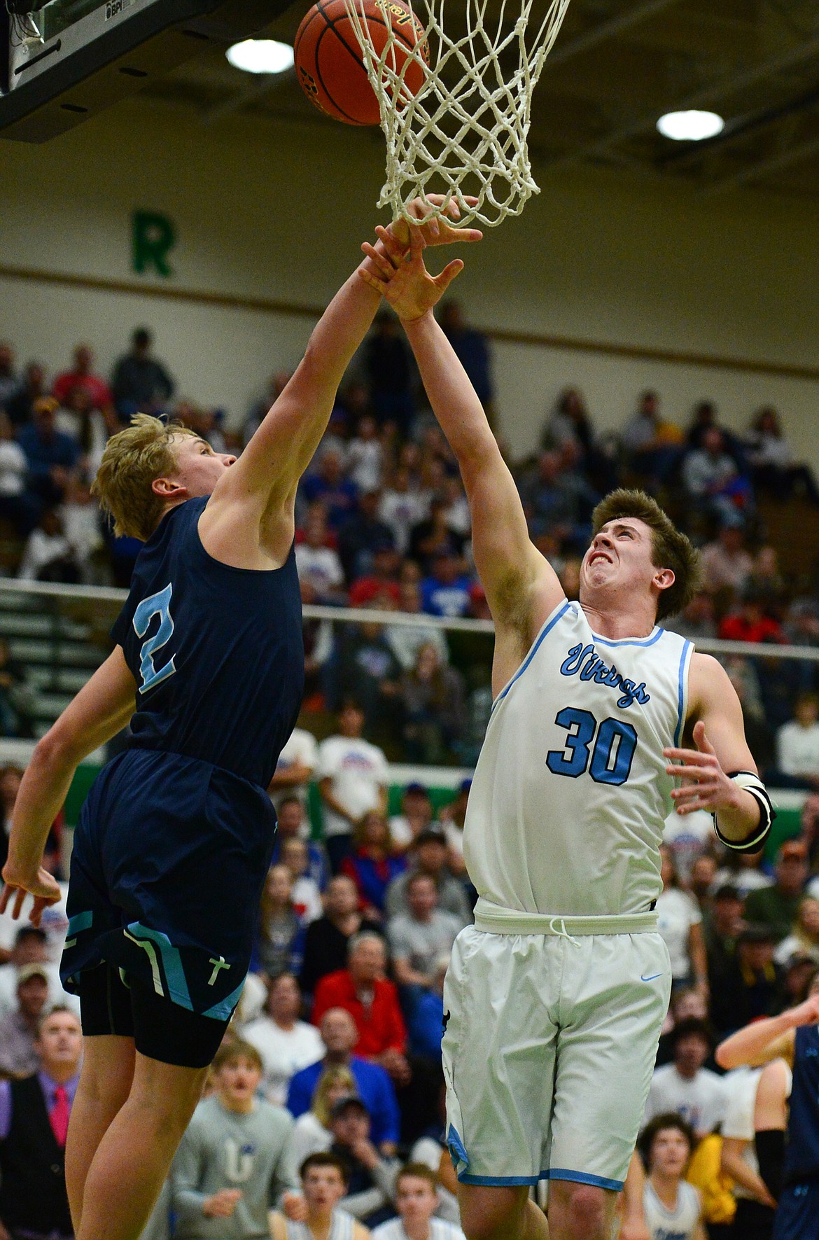 Bigfork's Logan Gilliard (30) drives to the hoop against Loyola Sacred Heart's Ryan Tirrell (2)  in the State Class B boys' basketball championship at the Belgrade Special Events Center in Belgrade on Friday. (Casey Kreider/Daily Inter Lake)