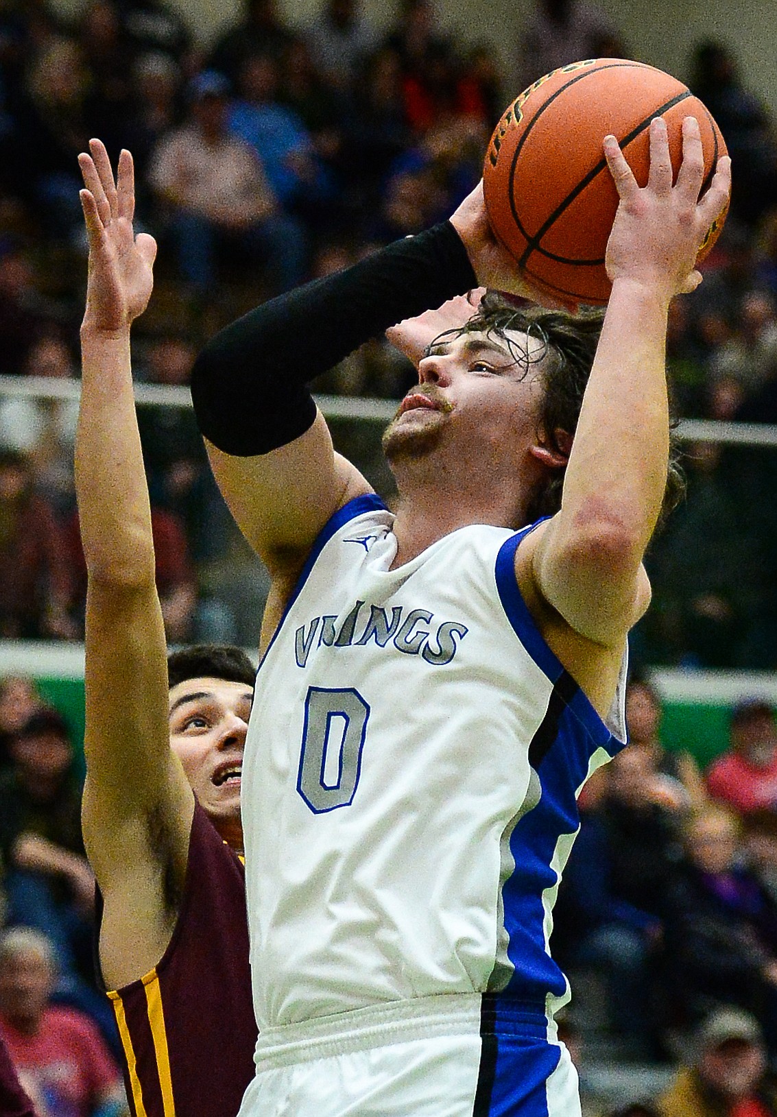 Bigfork's Anders Epperly (0) drives to the hoop past Poplar's Kenny Smoker (4) in the State Class B Boys' Basketball Tournament at the Belgrade Special Events Center in Belgrade on Thursday. (Casey Kreider/Daily Inter Lake)