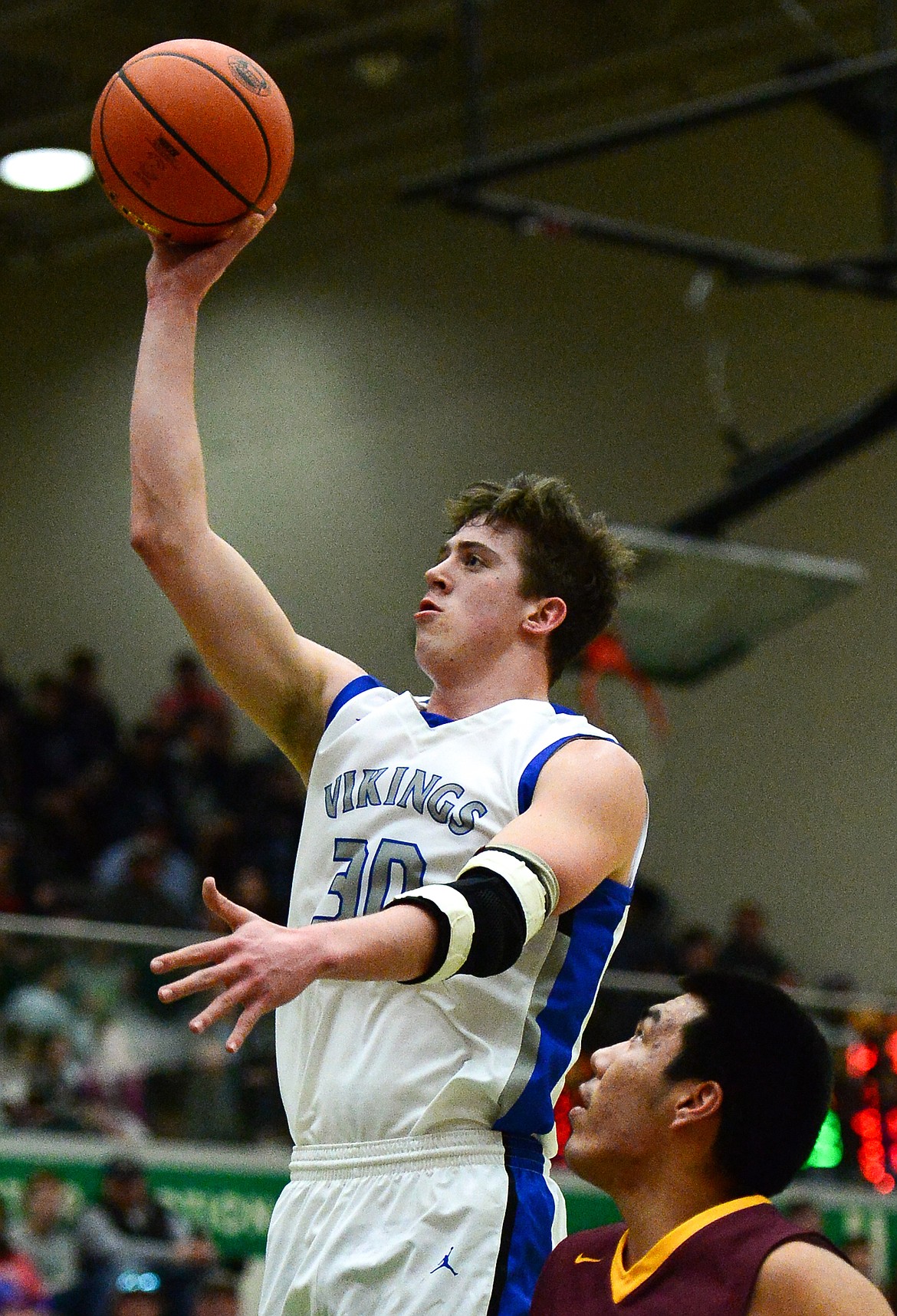 Bigfork's Logan Gilliard (30) drives to the hoop against Poplar in the State Class B Boys' Basketball Tournament at the Belgrade Special Events Center in Belgrade on Thursday. (Casey Kreider/Daily Inter Lake)