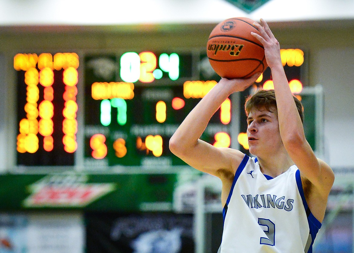 Bigfork's Colton Reichenbach (3) drains a three as time winds down in the first quarter against Poplar in the State Class B Boys' Basketball Tournament at the Belgrade Special Events Center in Belgrade on Thursday. (Casey Kreider/Daily Inter Lake)