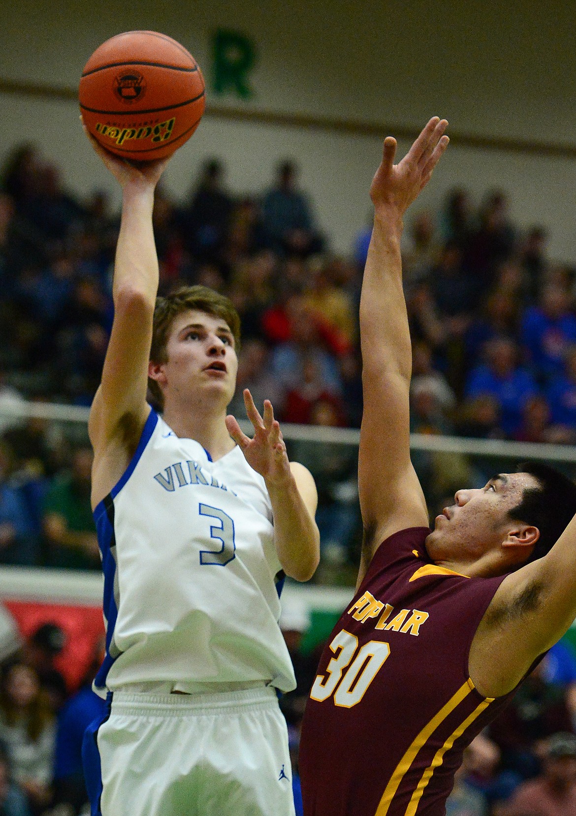 Bigfork's Colton Reichenbach (3) shoots over Poplar's Darryl Joe (30) in the State Class B Boys' Basketball Tournament at the Belgrade Special Events Center in Belgrade on Thursday. (Casey Kreider/Daily Inter Lake)