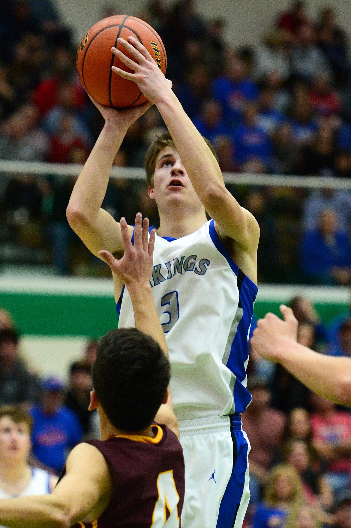Bigfork's Colton Reichenbach (3) shoots over Poplar's Kenny Smoker (4) in the State Class B Boys' Basketball Tournament at the Belgrade Special Events Center in Belgrade on Thursday. (Casey Kreider/Daily Inter Lake)