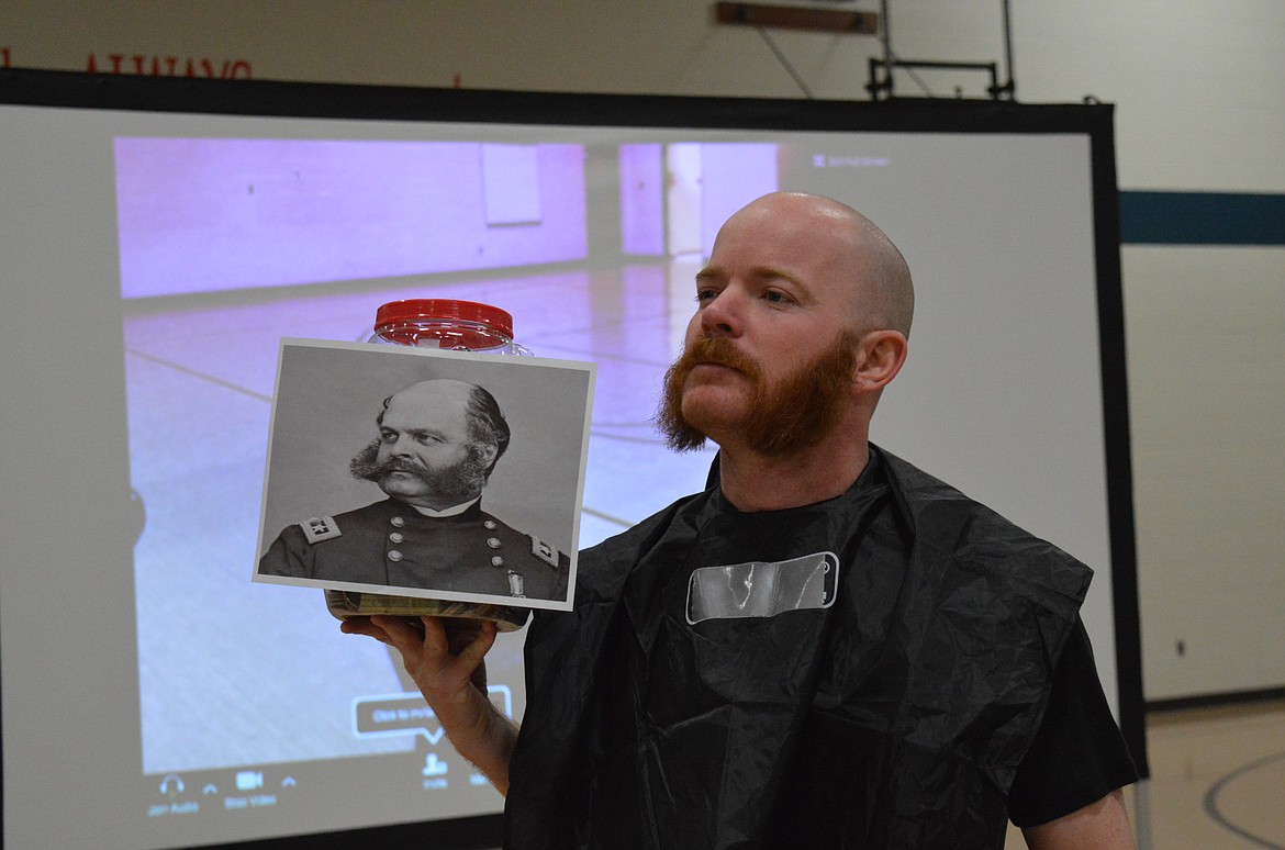 Patrick Johnston sports his new facial hair styled after Civil War General Ambrose Burnside. Students voted on what style Johnston should shave his beard by putting donations in jars for different beard styles to raise money for DREAM Adaptive Recreation.