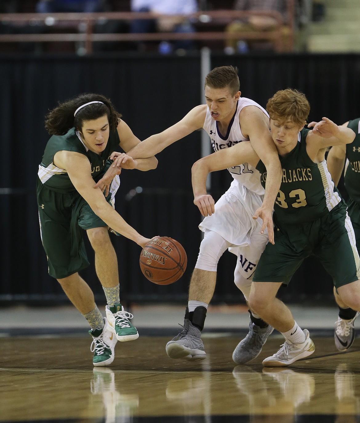 JASON DUCHOW/Jason Duchow Photography
St. Maries Jackson Pritchard (left) and Kaden Hammond battle North Fremonts Garrett Hawkes for a loose ball during the state 2A boys basketball championship game on Saturday at the Ford Idaho Center in Nampa.