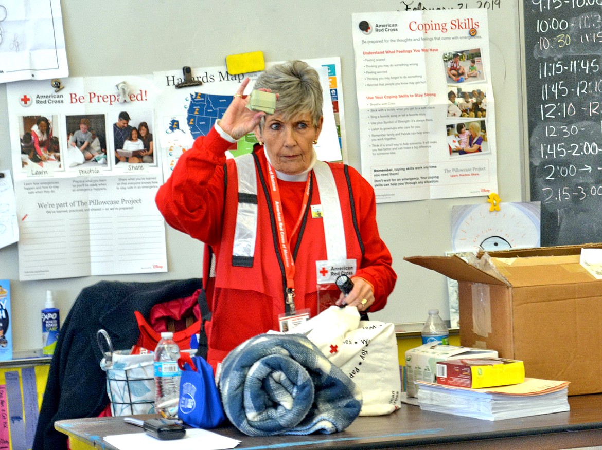 Retired teacher and Red Cross volunteer Sherry Baker of Kalispell, displays the essentials of a disaster preparedness kit during a recent presentation at Lakeside Elementary School.