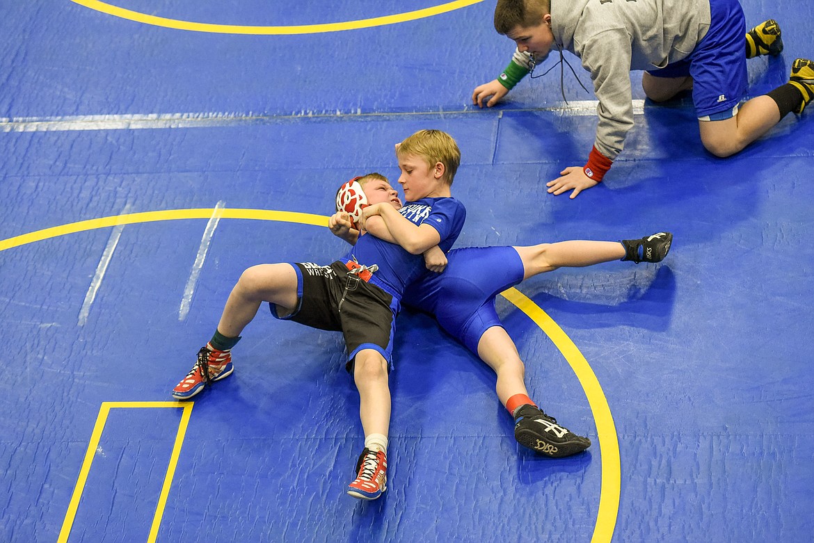 Collin Caley of Libby rolls to escape an attempt at a pin by Wyatt White of Bigfork at the Kootenai Klassic Wrestling Tournament Saturday. (Ben Kibbey/The Western News)