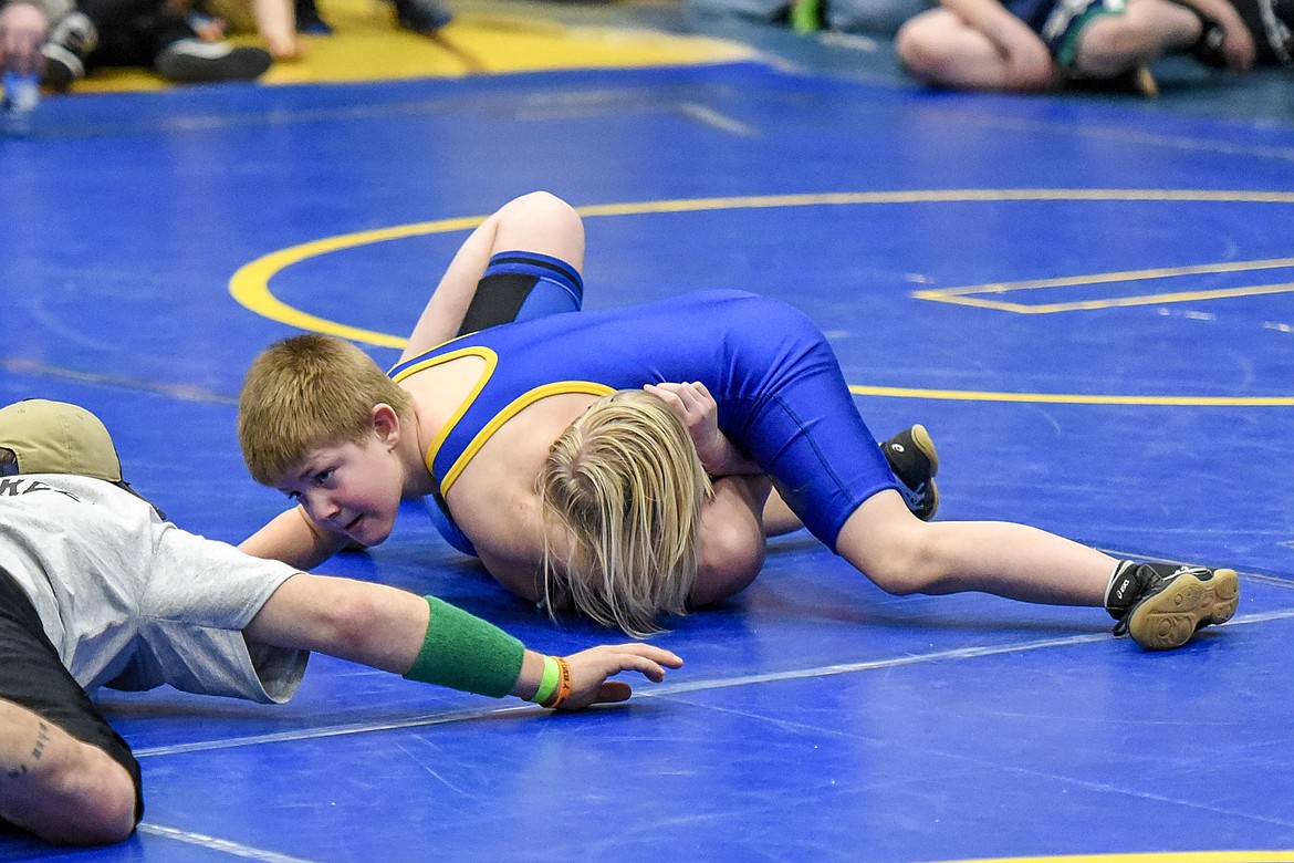 Logan Jellesed of Libby goes for a pin against Ariana Ensign of Kalispell at the Kootenai Klassic Wrestling Tournament Saturday. (Ben Kibbey/The Western News)