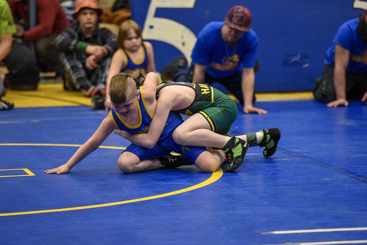 Isaiah Daggett of Libby works on an escape against Lyal Howell of Lakeland at the Kootenai Klassic Wrestling Tournament Saturday. (Ben Kibbey/The Western News)
