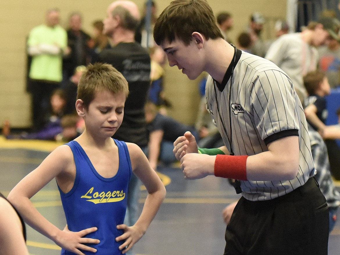 Blake Hoffman of Libby gets an explanation from match official Trey Thompson at the Kootenai Klassic Wrestling Tournament Saturday. (Ben Kibbey/The Western News)