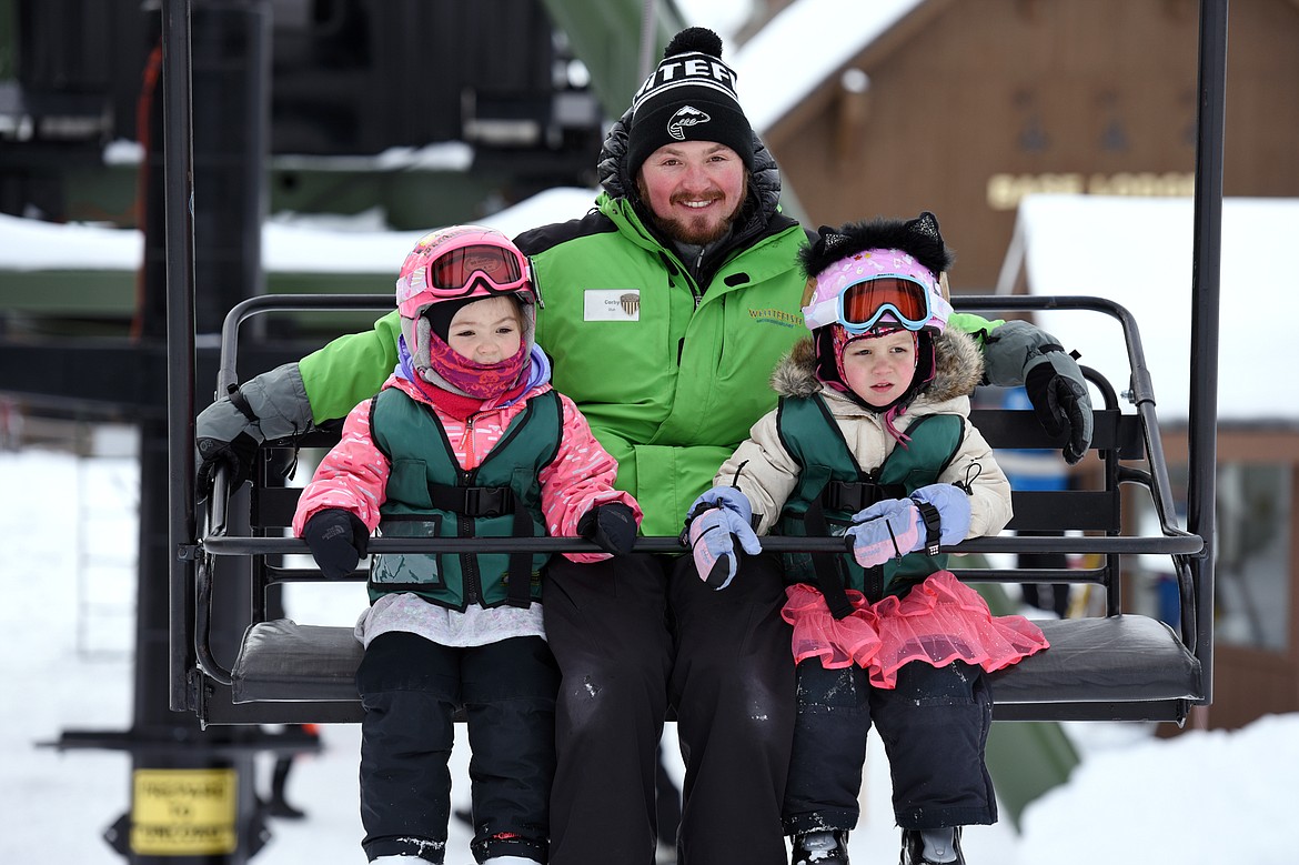 Emma Dotter, left, and Gracyn Pohlman, right, ride Chair 6 with instructor Corby Fuhriman during the Buckaroo Ski Program at Whitefish Mountain Resort on Wednesday, Feb. 27. (Casey Kreider/Daily Inter Lake)