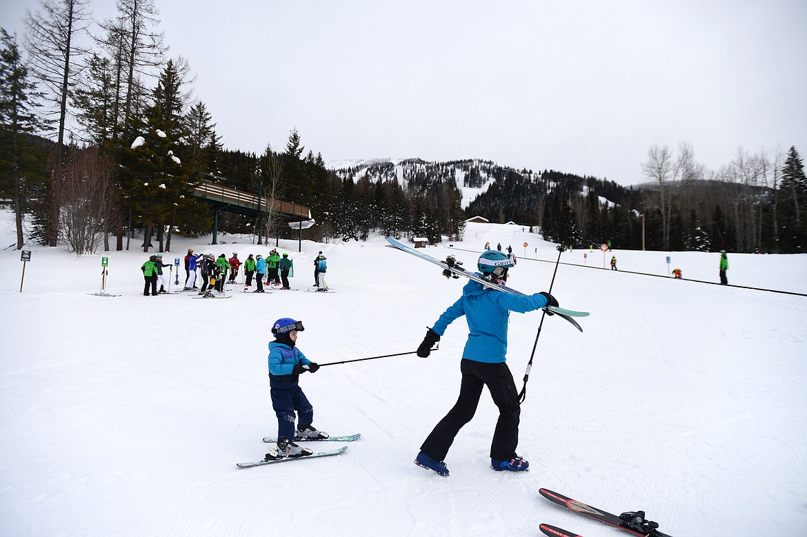 A young skier gets a tow to the Big Easy Conveyor Carpet before the start of the Buckaroo Ski Program at Whitefish Mountain Resort on Wednesday, Feb. 27. (Casey Kreider/Daily Inter Lake)