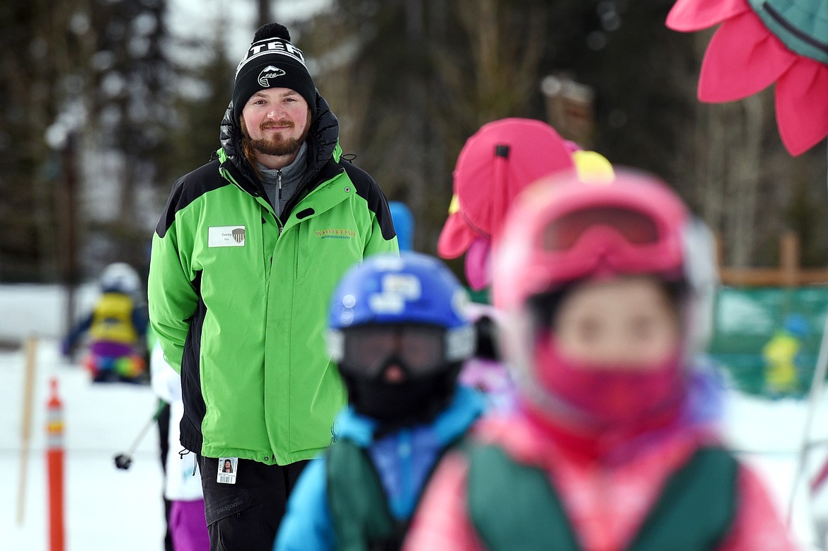 Instructor Corby Fuhriman follows his young ski students up the Big Easy Conveyor Carpet during the Buckaroo Ski Program at Whitefish Mountain Resort on Wednesday, Feb. 27. (Casey Kreider/Daily Inter Lake)