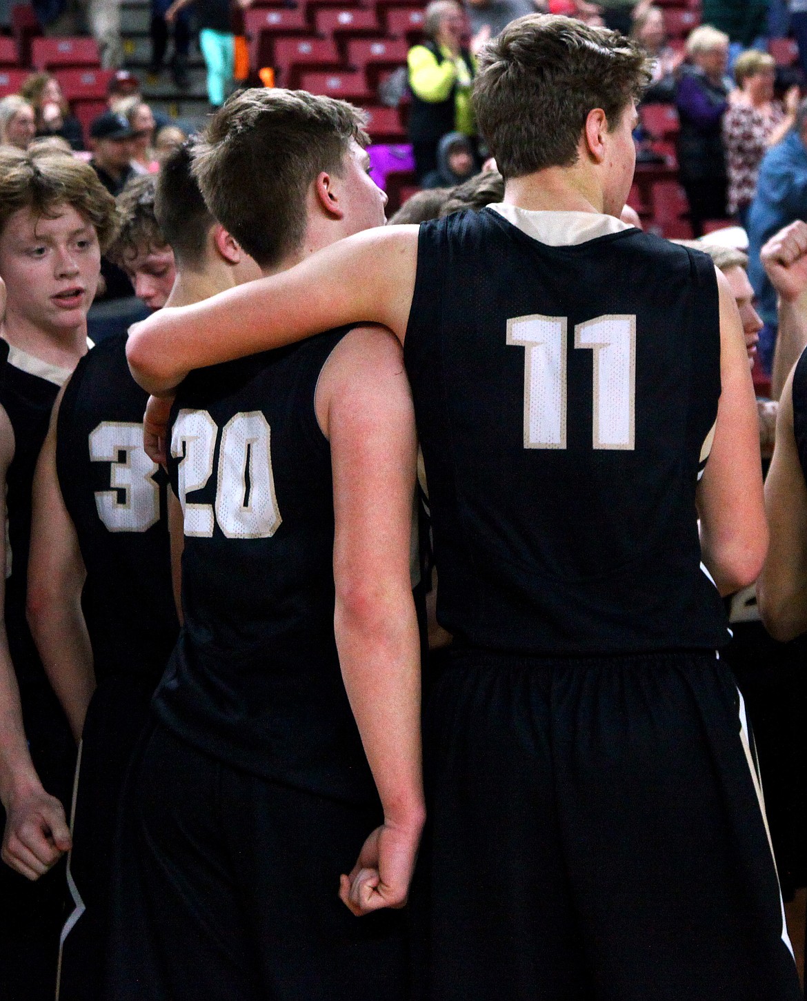 Rodney Harwood/Sun TribuneRoyal senior Sawyer Jenks (11) puts his arm arould Caleb Christensen (20) and takes a moment to enjoy the Yakima SunDome with teammates following the Knights first-round loss to Connell at the 1A Hardwood Classic.