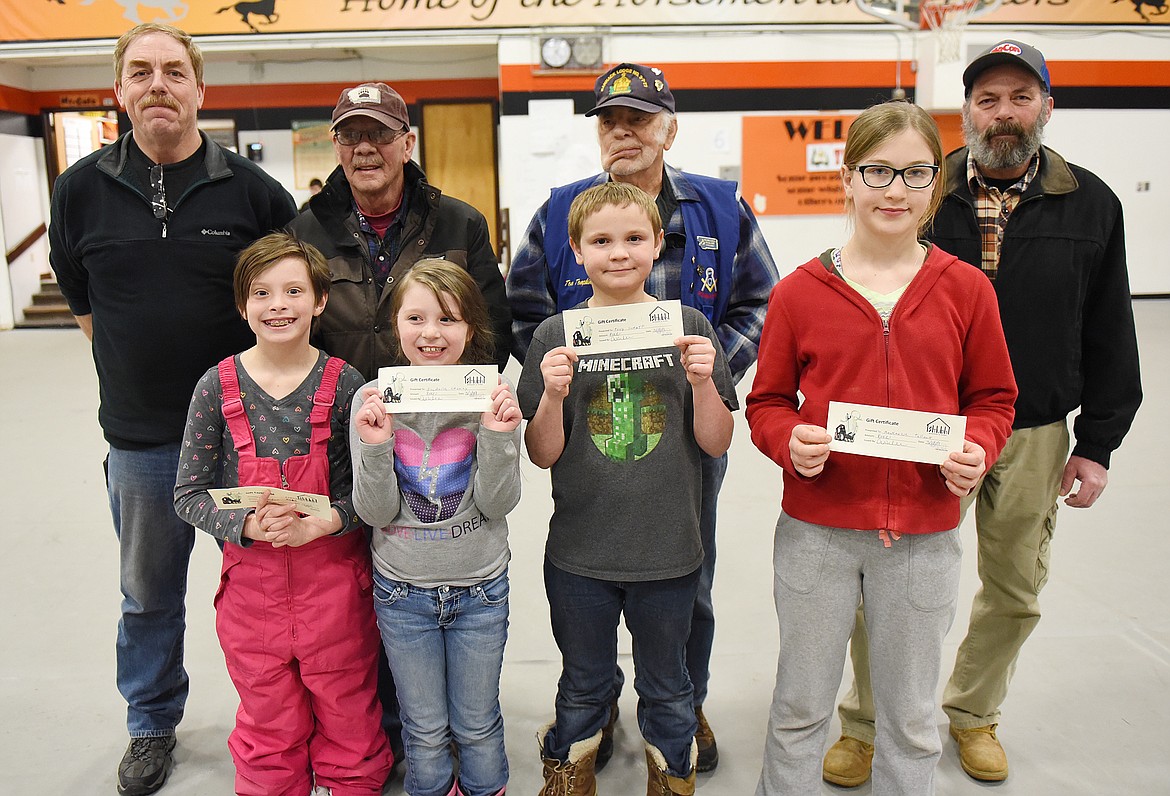 WINNERS OF bicycles donated by Plains Masons Ponemah Lodge 63 to culminate the I Love to Read program last Friday were, from left, Jordyn Bagacisau, Isabella Chaney, Antoine Schaff and Mackenzie Tulloch. The other winner, Vince Heathers, was not present. In the back row are Plains Masons, from left, Ron Warren, Bill Burrell, Tom Tompkins Sr. and Tom Tompkins Jr. (Joe Sova/Clark Fork Valley Press)