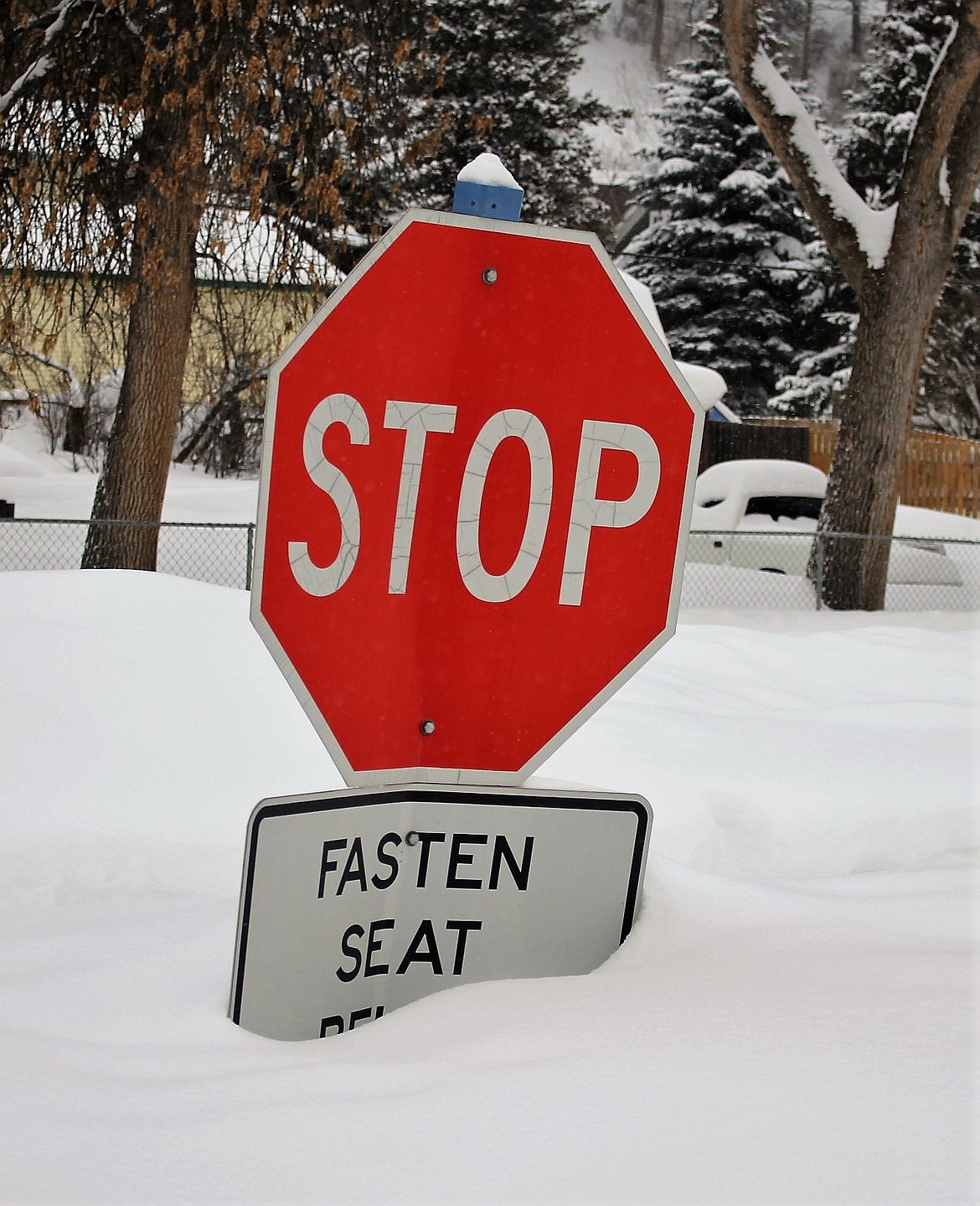 Deep snowbanks nearly buried a stop sign in Mineral County last week with depths not seen in nearly 30 years. (Kathleen Woodford/Mineral Independent)