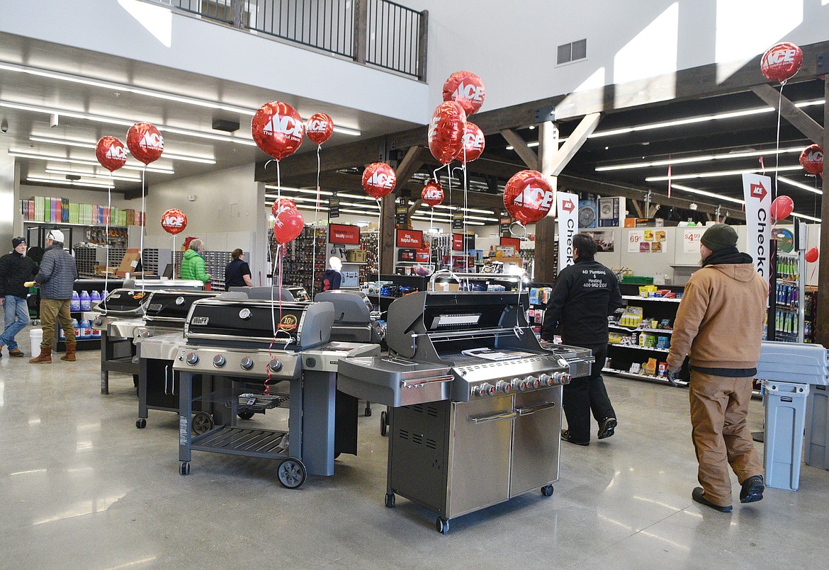 Customers enter the new Nelson&#146;s Ace Hardware store Monday morning. The new store has room to display many items including grills that the old store on Central Avenue didn&#146;t have enough space for. (Heidi Desch/Whitefish Pilot)