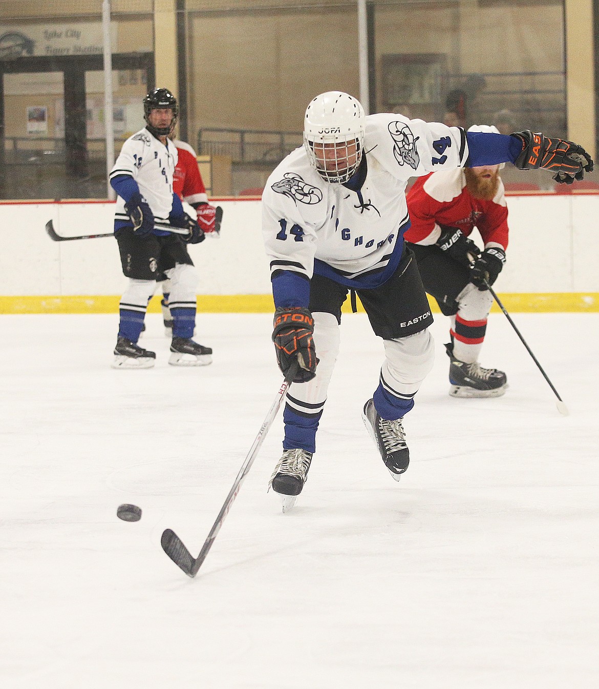Matt Fischer of the Bighorns goes after a loose puck in a match against Caddyshack.