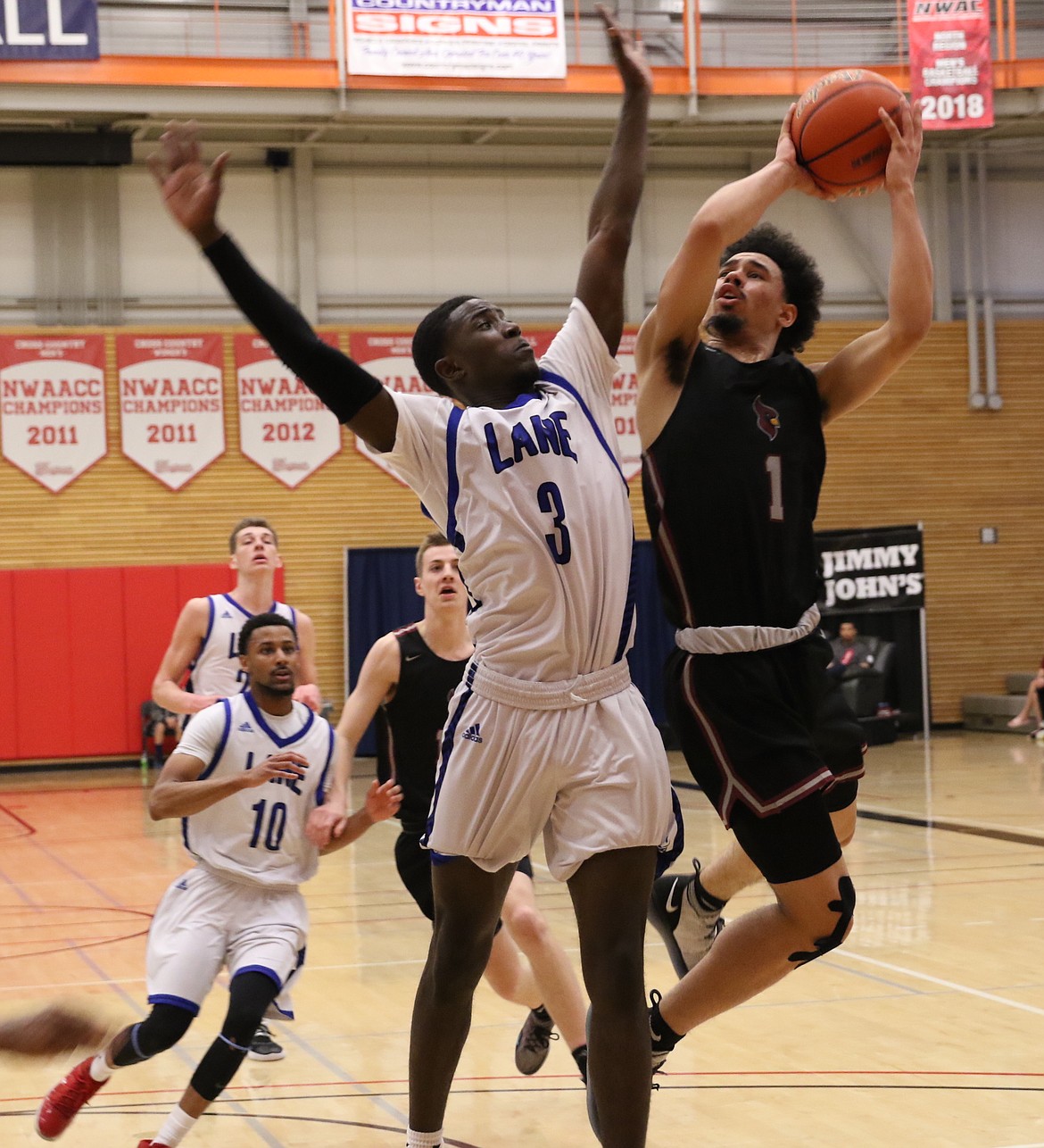 TRACY SWISHER/Northwest Athletic Conference
Nate Pryor (1) of North Idaho College drives to the basket against Lezjon Bonds (3) of Lane Community College in a semifinal game of the Northwest Athletic Conference men&#146;s basketball tournament Saturday in Everett, Wash.