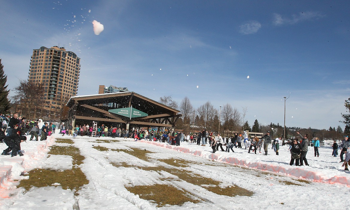 Kids of every age lob snowballs into the air Saturday in McEuen Park. (DEVIN WEEKS/Press)