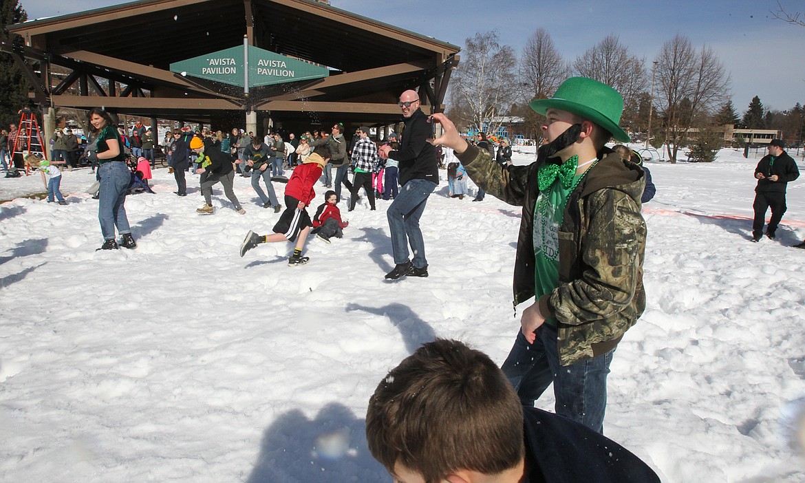 St. Patrick&#146;s Day-ready Tyler Killingsworth, 12, of Coeur d&#146;Alene, pauses to document some of the action during the biggest snowball fight in Lake City history. More than 300 people of all ages joined in the fun. (DEVIN WEEKS/Press)