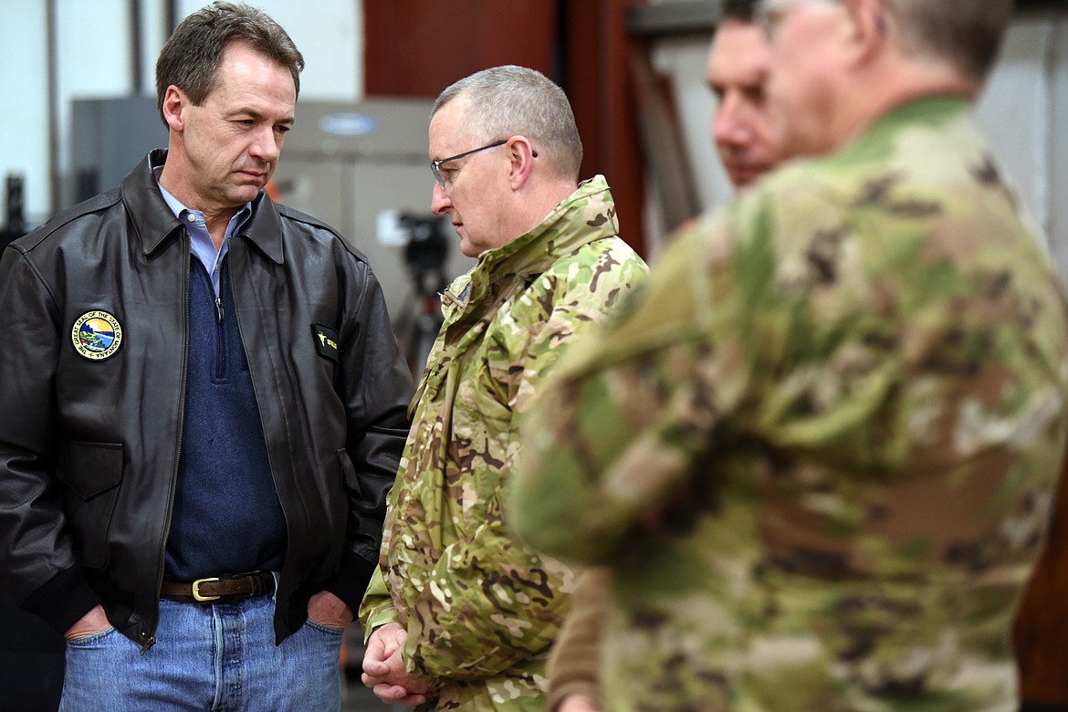 Governor Steve Bullock speaks with the Adjutant General of Montana Maj. Gen. Matthew Quinn as they await the arrival of members of the Montana National Guard 495th Combat Sustainment Support Battalion on Saturday night, March 16. Quinn, the governor and others were on site at the Glacier Jet Center to thank and welcome the unit home. The 495th has been deployed since May 2018.(Brenda Ahearn/Daily Inter Lake)