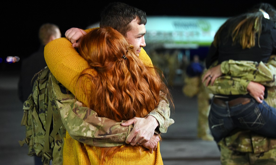 Sgt. Tyler Johnson is hugged as he reaches the Glacier Jet Center and the families waiting to reunite with members of the Montana National Guard 495th Combat Sustainment Support Battalion who have been deployed to Afghanistan since May 2018.(Brenda Ahearn/Daily Inter Lake)