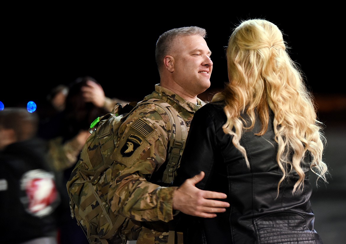 Sgt. 1st Class Ryan Berry greets his wife Holly at the homecoming celebration for the Montana National Guard 495th Combat Sustainment Support Battalion on Saturday night, March 16, at the Glacier Jet Center. (Brenda Ahearn/Daily Inter Lake)