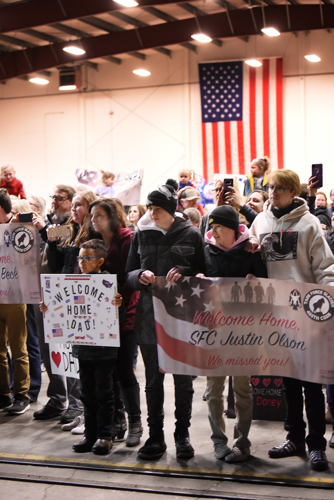 Families anxiously waiting for their loved ones to arrive at the Glacier Jet Center on Saturday night, March 16. Members of the Montana National Guard 495th Combat Sustainment Support Battalion, who have been deployed to Afghanistan since May 2018, arrived home on Saturday.(Brenda Ahearn/Daily Inter Lake)