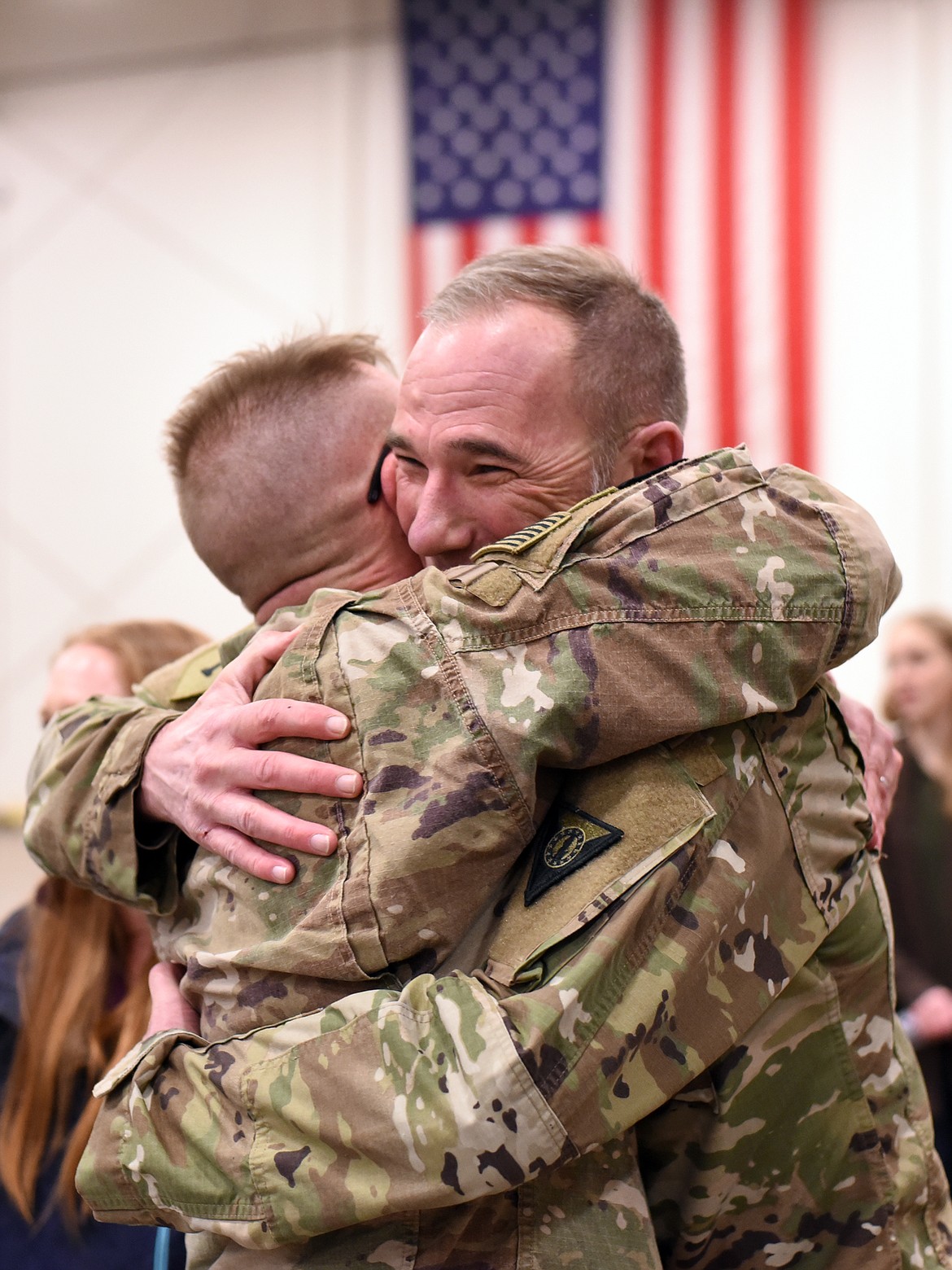 Master Sgt. Mike Hardesty hugs Capt. Dan Bushnell at the homecoming celebration for the Montana National Guard 495th Combat Sustainment Support Battalion. Hardesty was with Bushnell and other members of the unit for their previous deployment in 2012-2013.(Brenda Ahearn/Daily Inter Lake)