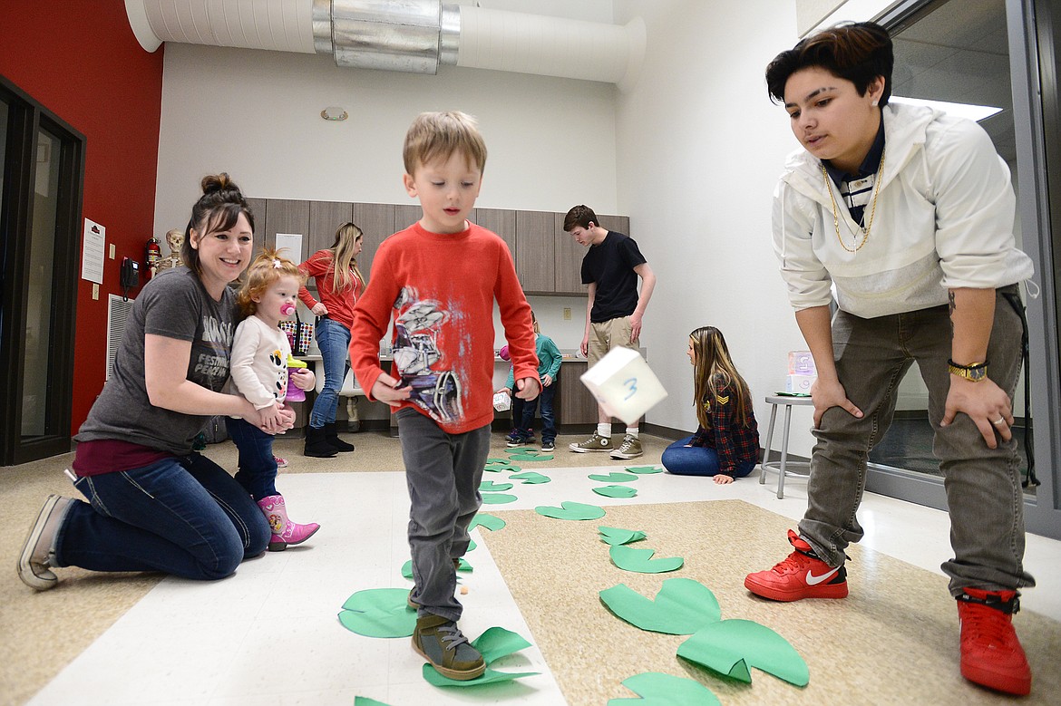Carter Johnson plays a lily pad game during Pre-K Pi(e) Day at Peterson Elementary on Wednesday. It was one of several fun activities organized by preschool parents that involved numbers, counting, patterns and shapes. Flathead High School Early Education 2 students helped lead the activities. (Casey Kreider/Daily Inter Lake)