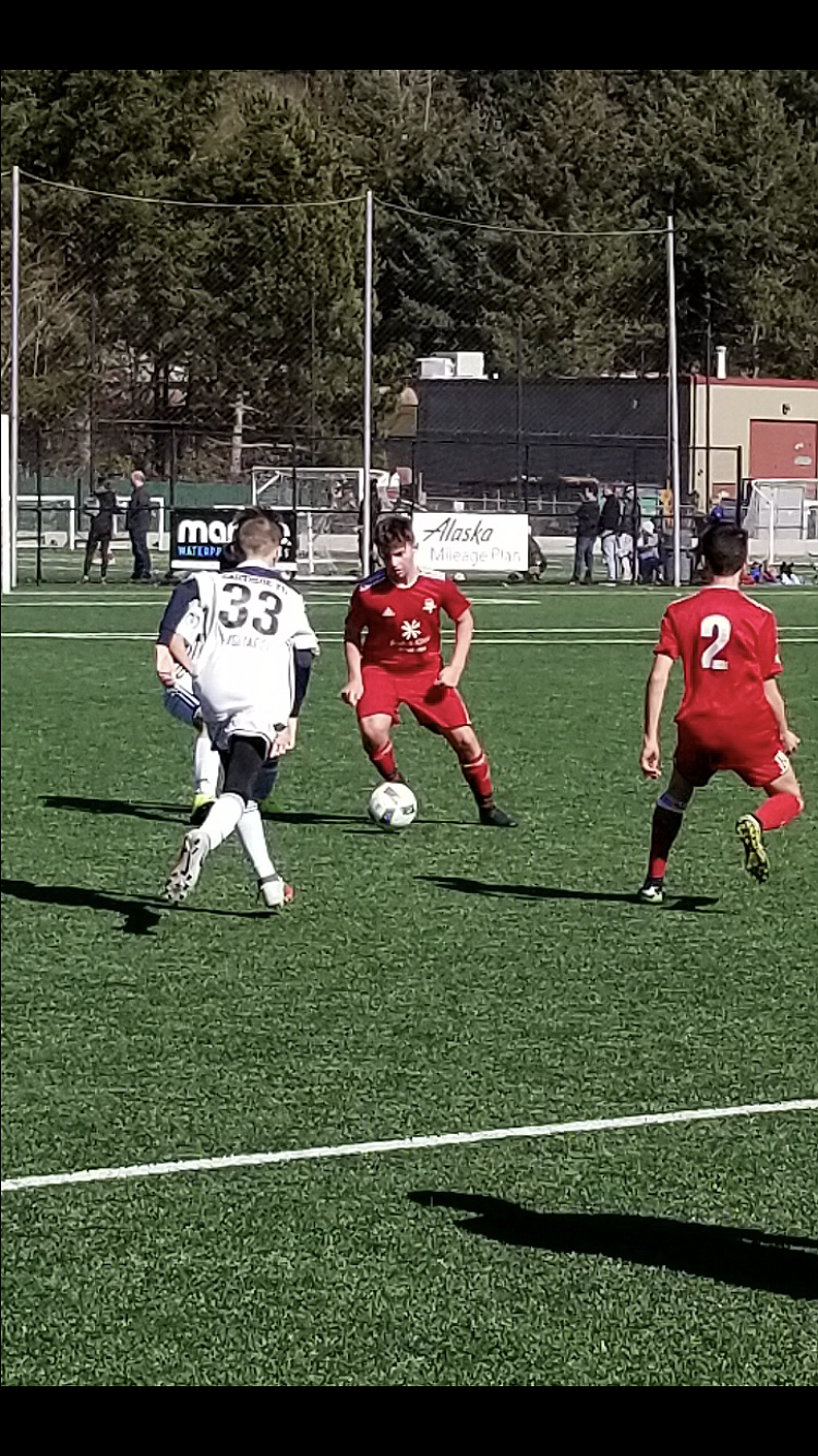 Courtesy photo
Cooper Prohaska of the Timbers North FC 05 Red boys soccer team works his way past Eastside FC players.